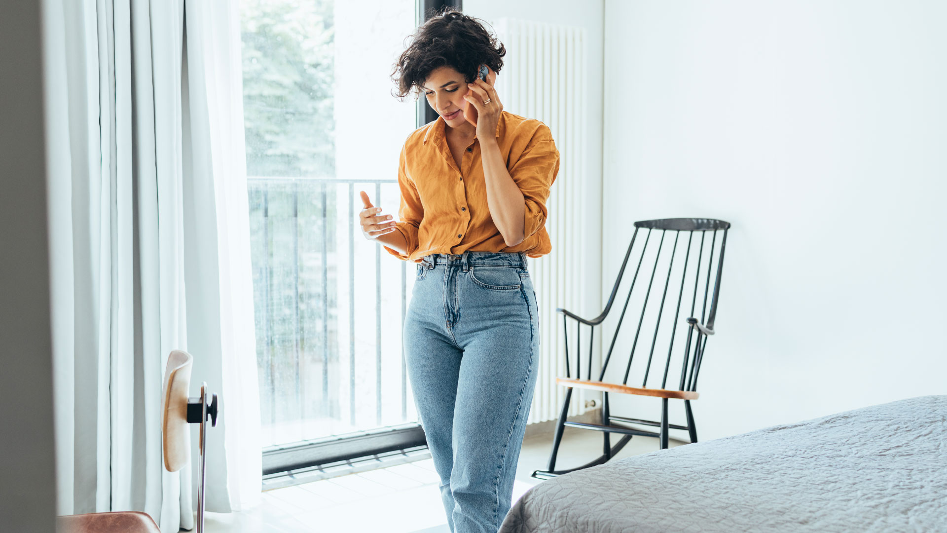 A woman on the phone negotiating the sale of her property with an interested buyer.