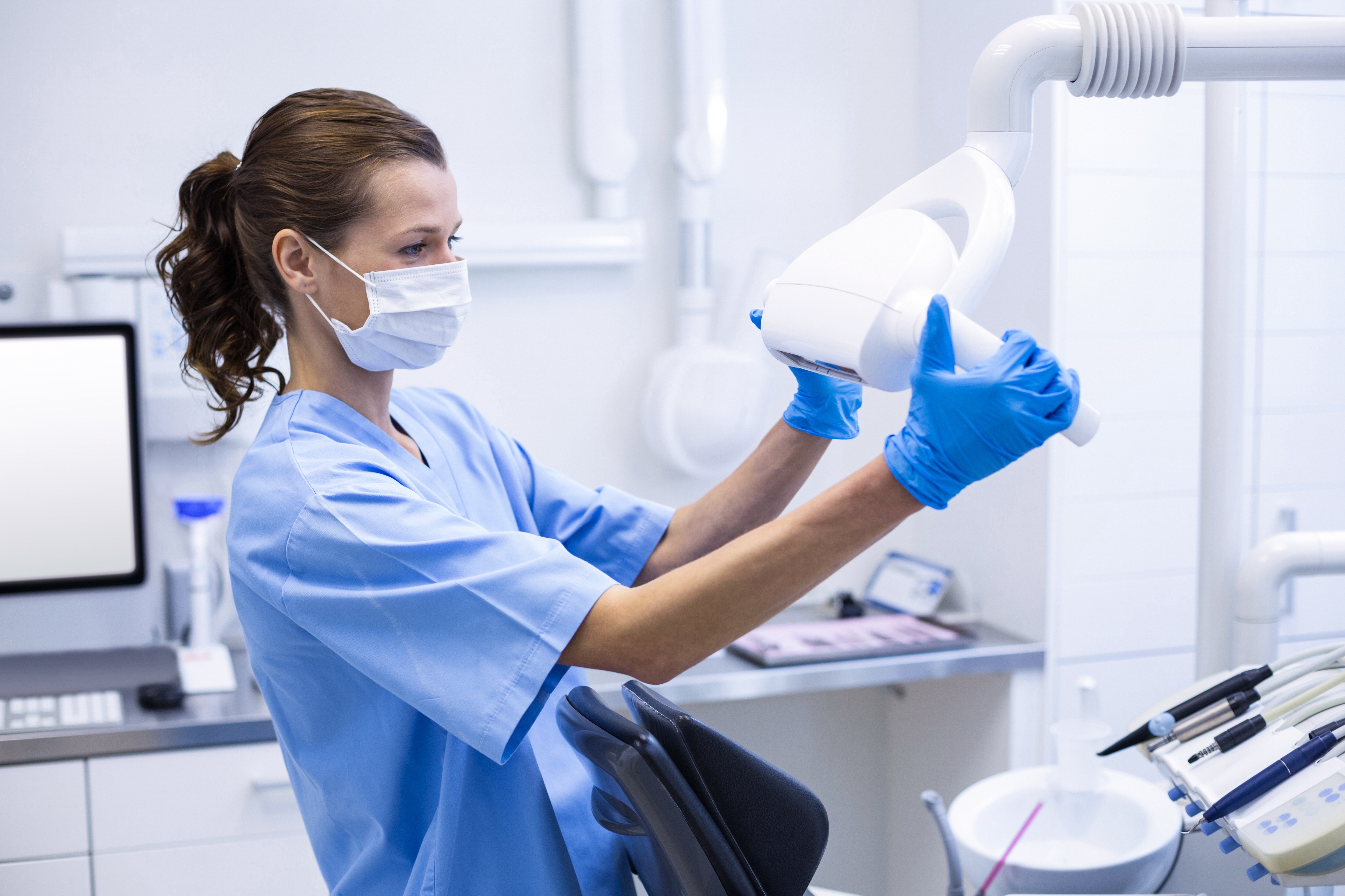 Dental assistant cleaning the equipment