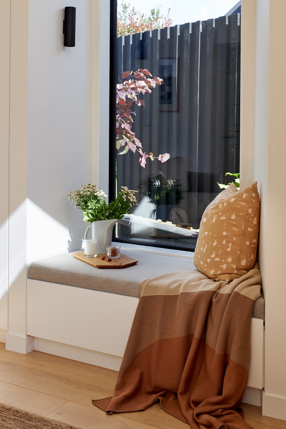 A pull-out drawer keeps books contained and close to hand in this wee reading nook. Photo: Simon Wilson