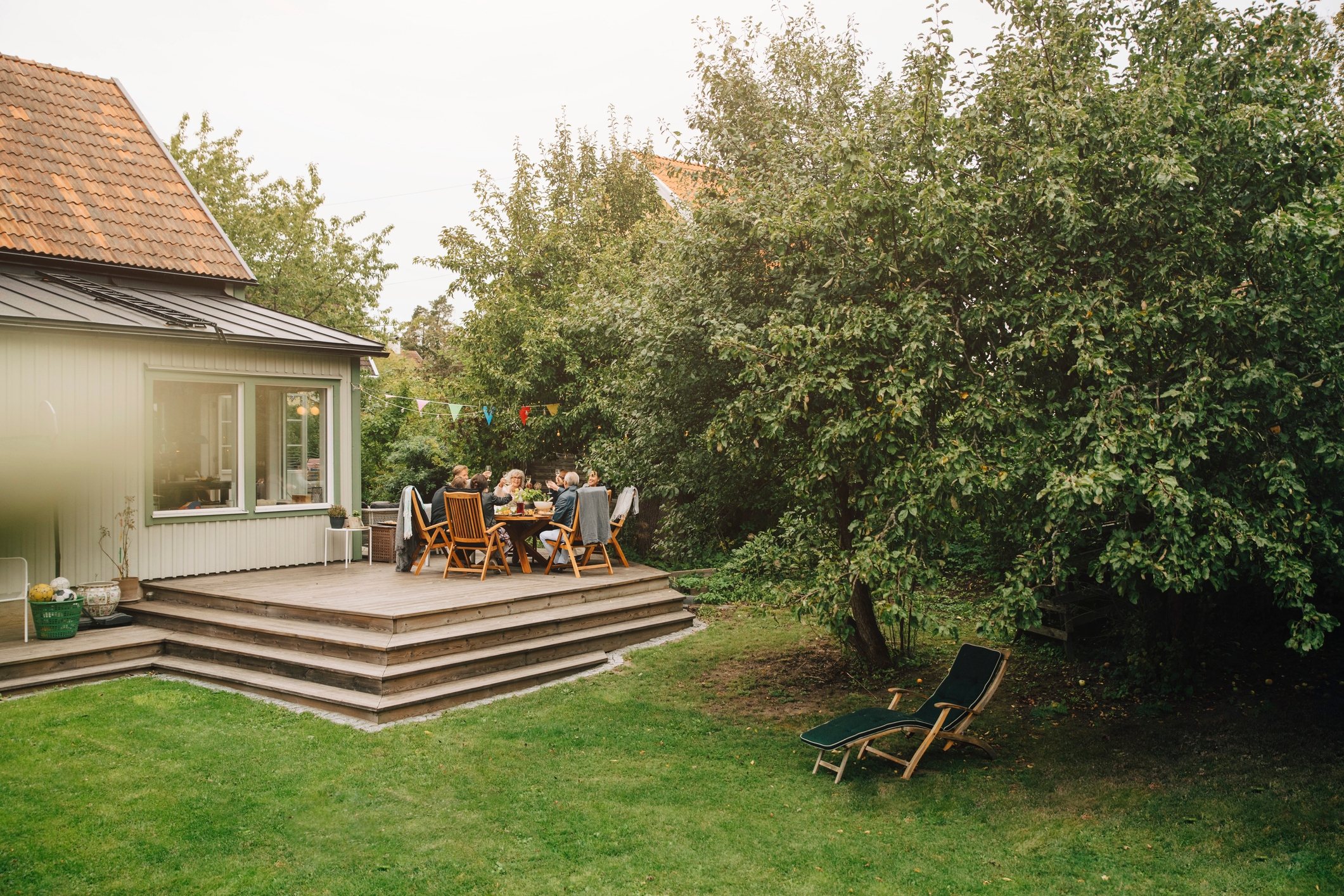 Whānau having a BBQ on their deck