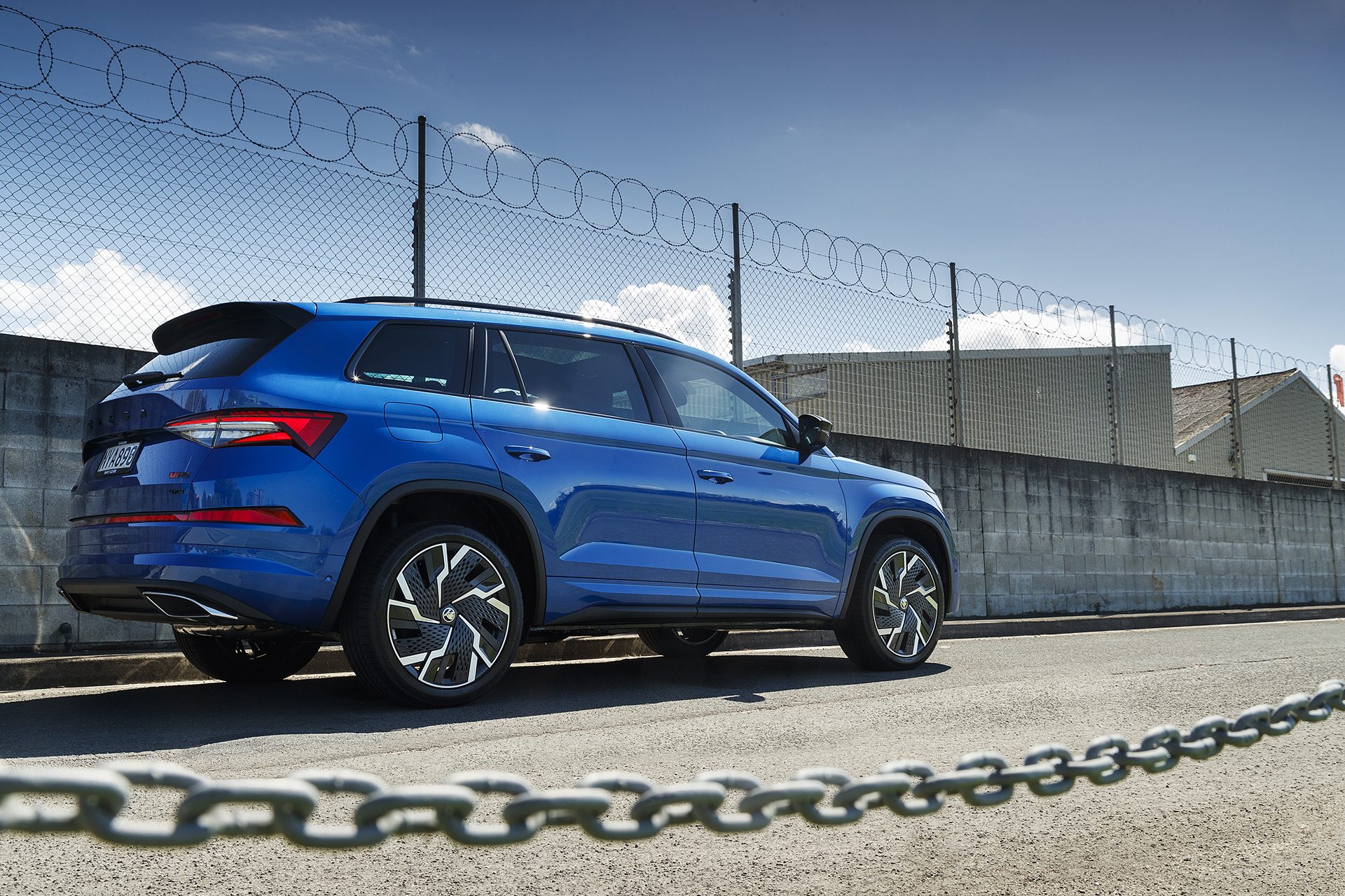 Blue Skoda Kodiaq RS stationary shot from the rear.