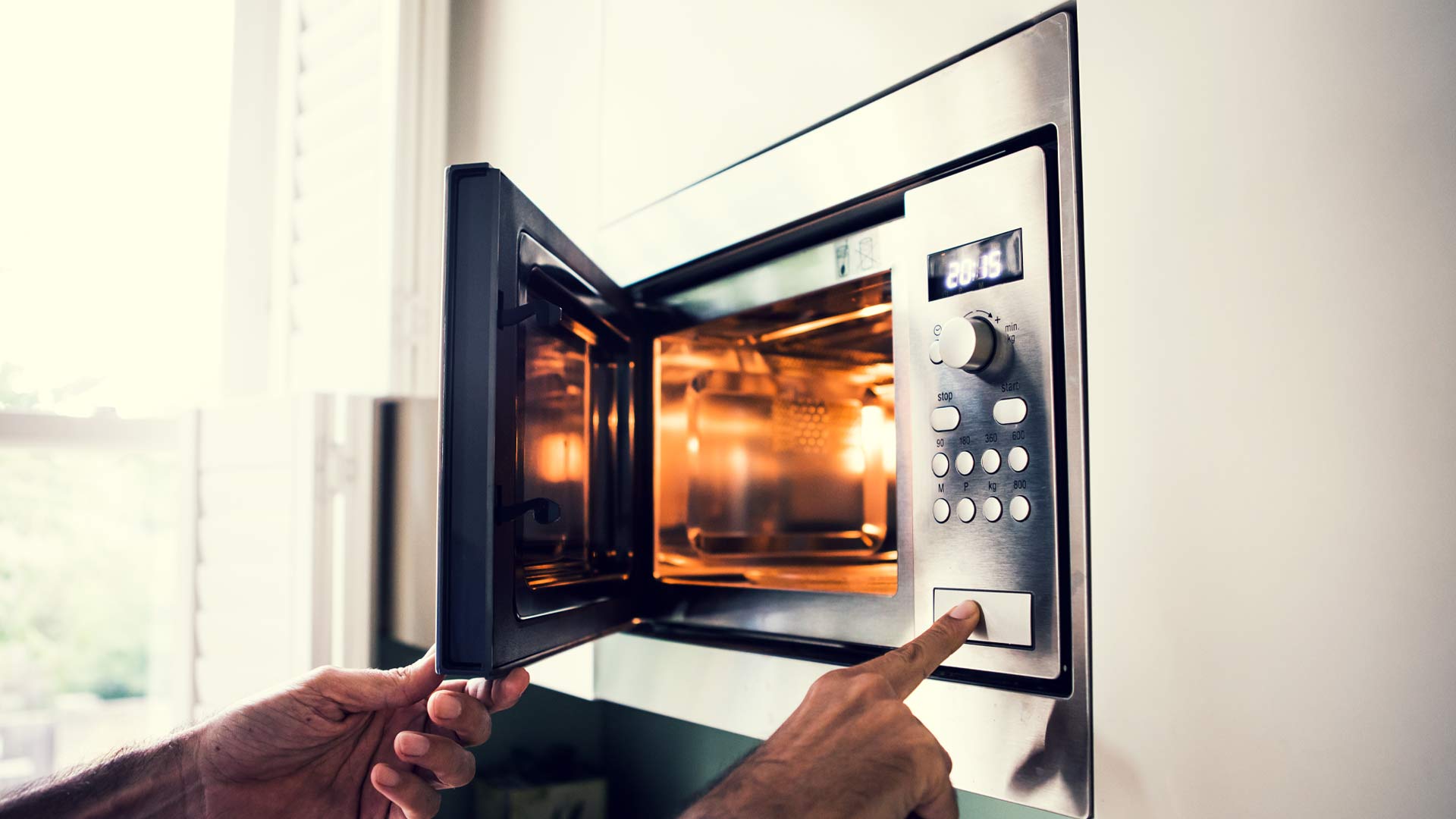 Person opening microwave.