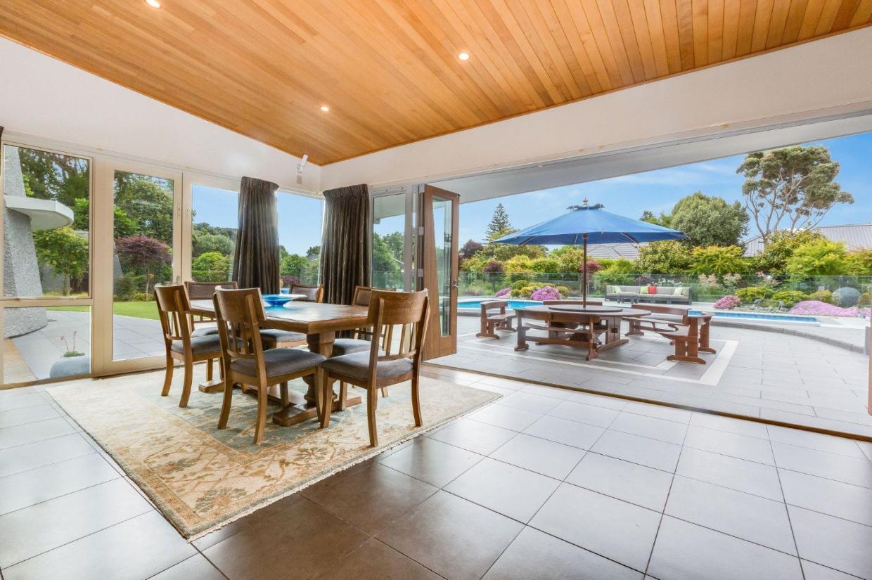 The living room doors open up to the incredible exterior