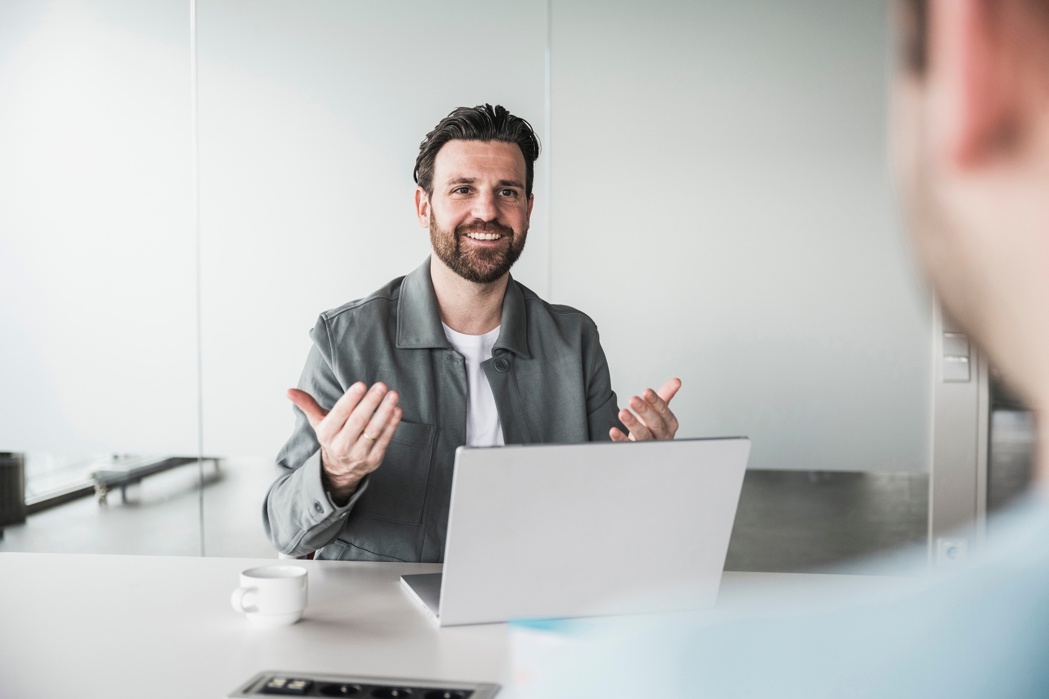 Man with open laptop, trying to attract a talented candidate