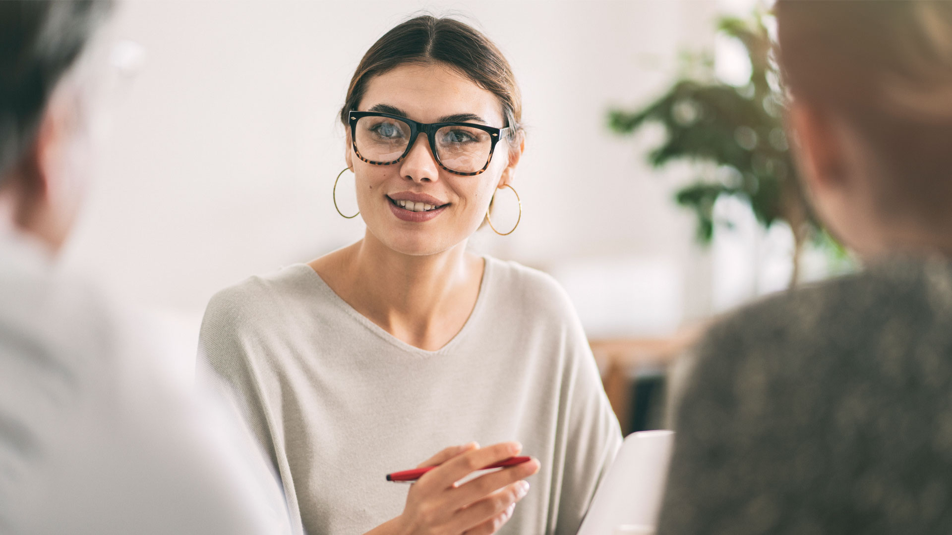 A real estate agent talking to some prospective clients in her office.