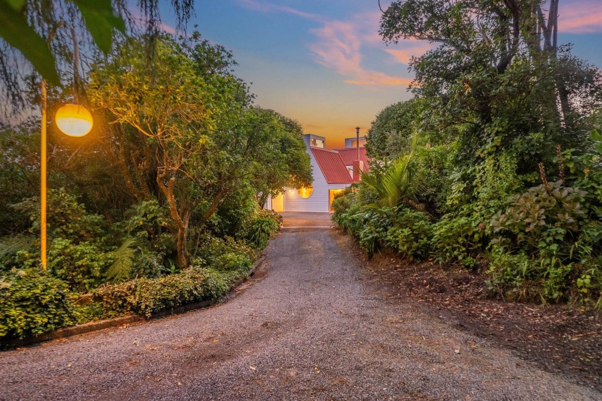 Spacious driveway heading up to property, lots of nice vegetaion.
