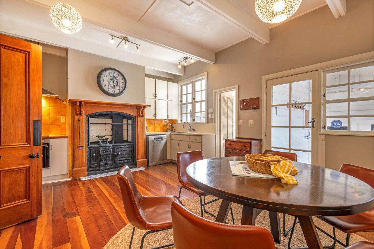 The kitchen work spaces wrap around the sides of the large room. The door at right opens to a walled courtyard leading to the converted stables.