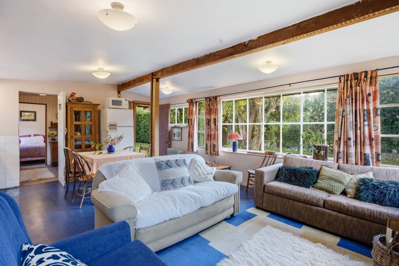 As with every ‘60s crib (or bach if you live in the north), the furniture has been a bit of this and a bit of that. The curtains are the original ones Ann Campbell made. Photo: Nidd Realty