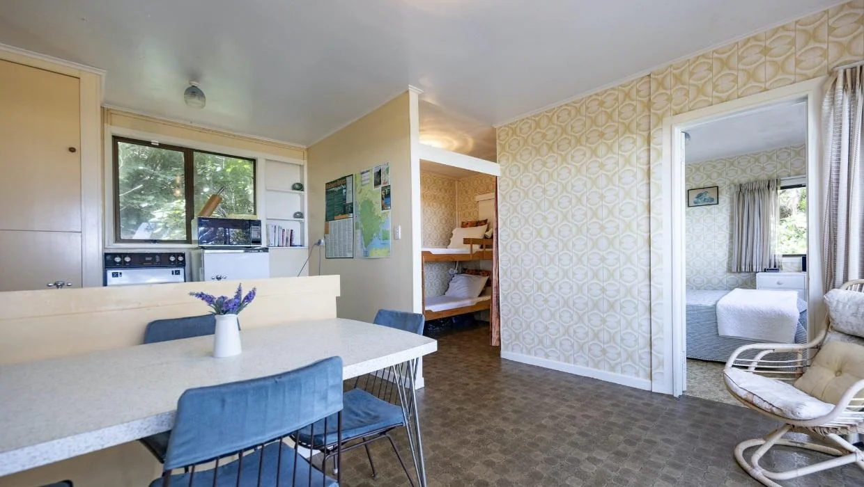 Bunk beds are tucked around the corner at the rear of the open-plan living space.