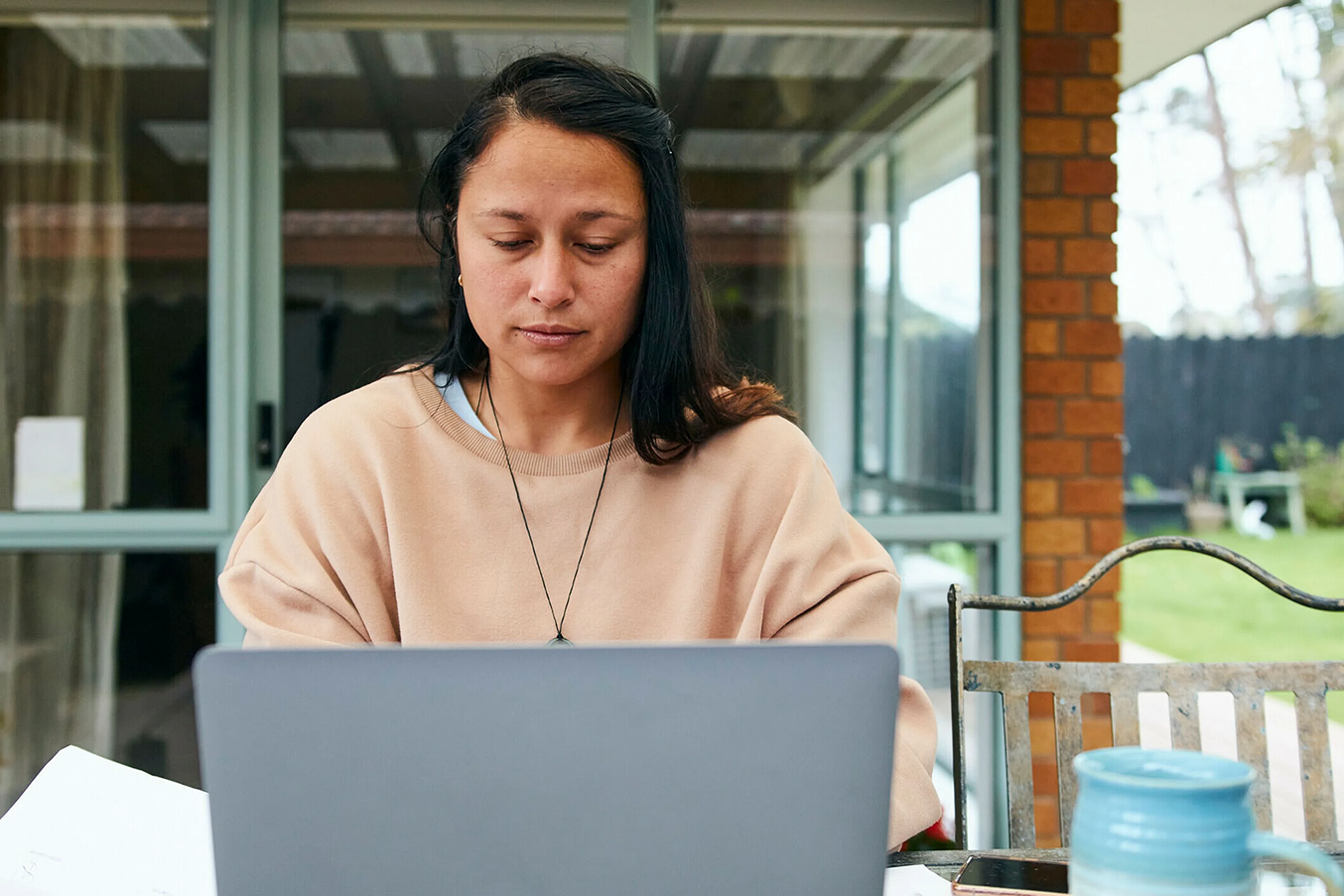 Woman writing a cover letter on her laptop.