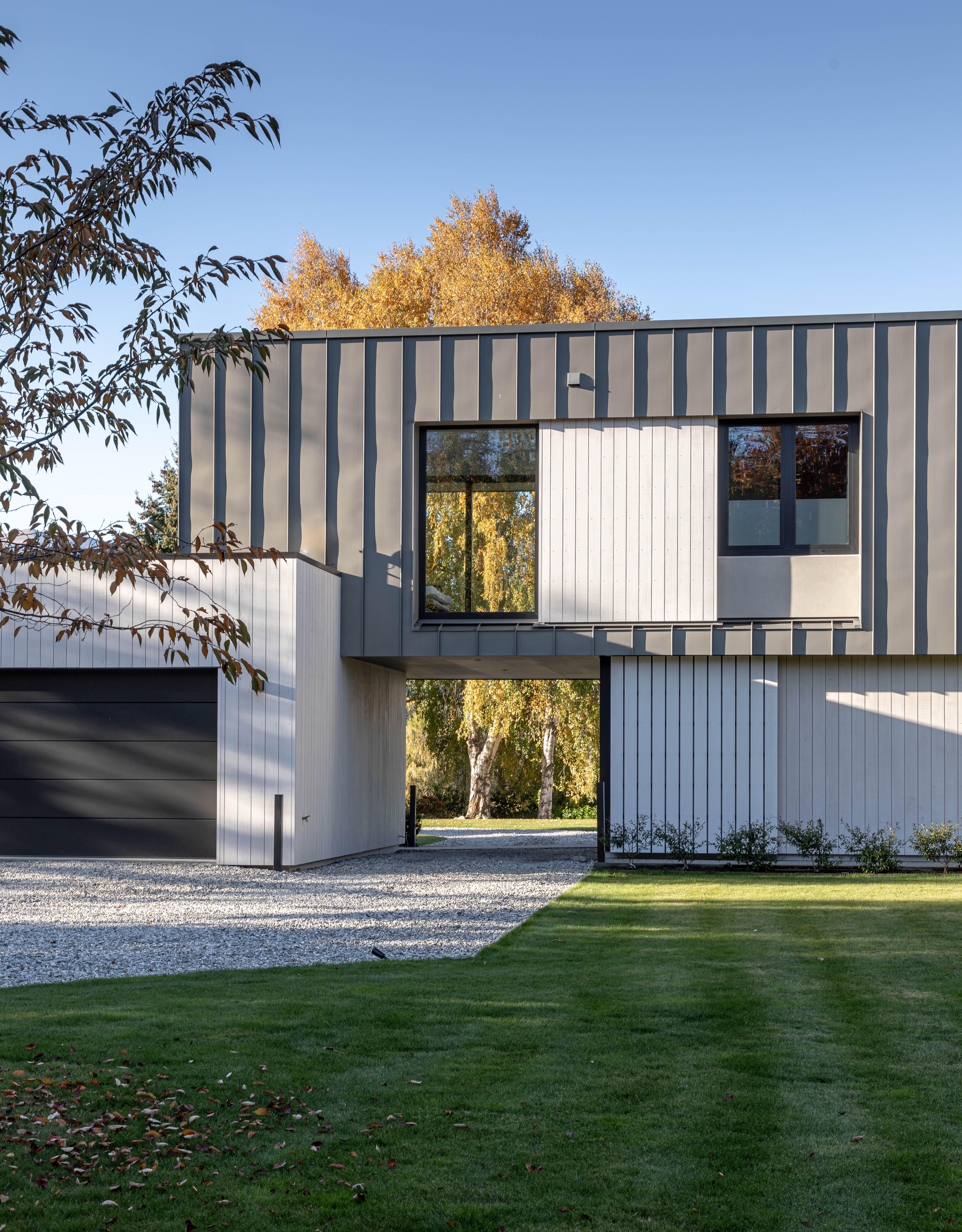 Designed by KOIA Architects, this home is wrapped in zinc and thermally modified timber cladding allowing the substantial form to sit lightly in the landscape. Image by John Williams.