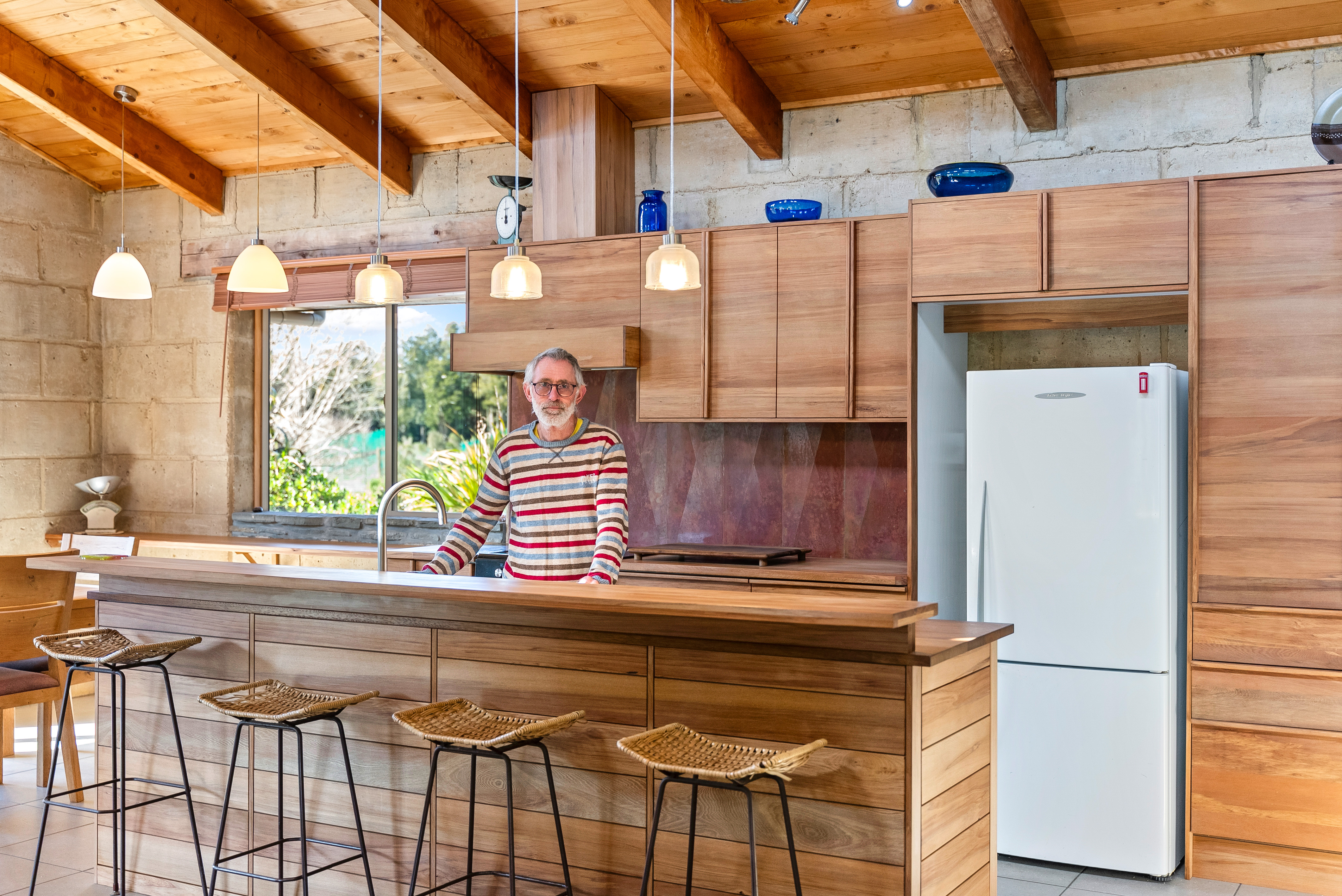 Murray in the kitchen he built from windblown kauri
