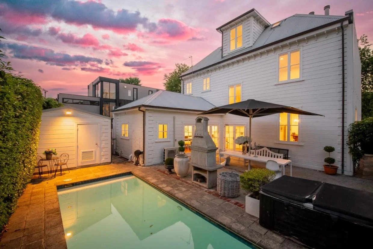 A heated pool, spa, outdoor fireplace and alfresco dining area are features of the rear courtyard.