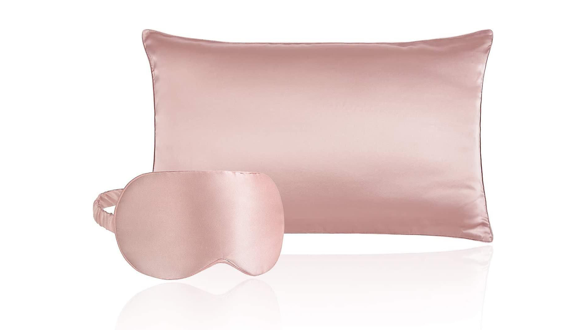 A salmon pink silk pillowcase and eyemask sleep set.