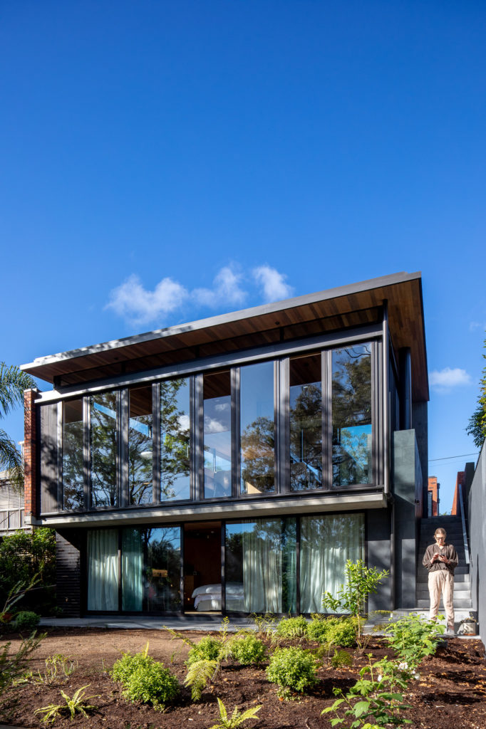 External house windows and a lady on her phone