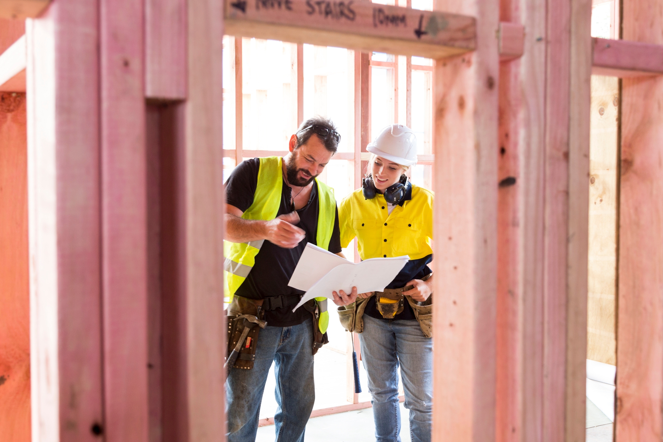 Two builders looking at plans. Finance new home. 