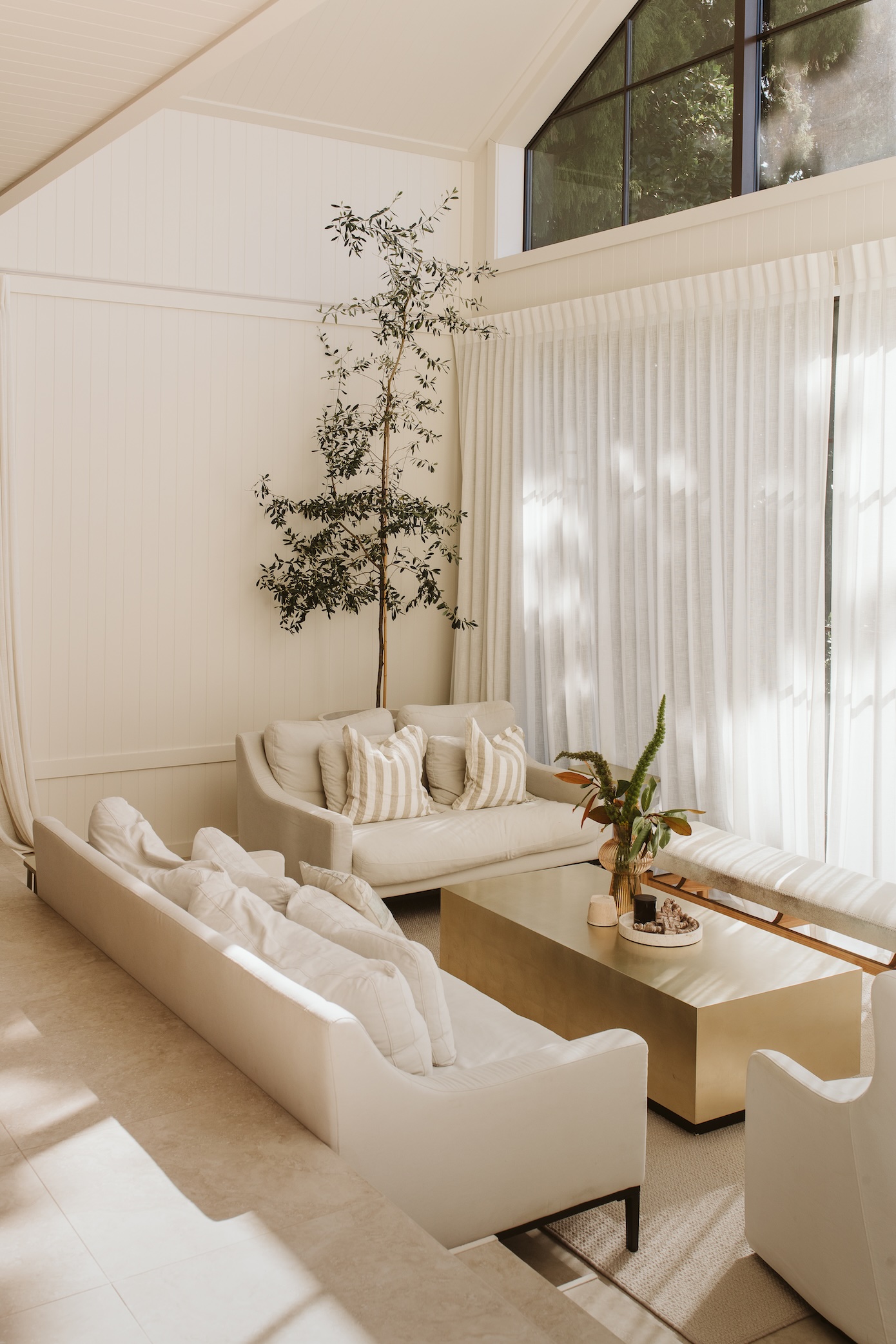 Walls in Porter’s Paints Old Church White lend tranquillity to the backdrop. In the living room a sofa sourced from Hawthorne Collections and Cape Cod chairs from Clegg’s are dressed with playful cabana stripe cushions from Weave. The rug, which was custom made, matches the upstairs Cavalier Bremworth St Moritz carpet in colour Switzerland. A Cocktail Couture coffee table from SR Interiors adds a hint of sparkle while an olive tree in a pot brings nature indoors. “It has grown immensely and, due to the height of the space, has a fair bit still to go if it likes,” says Jemma.