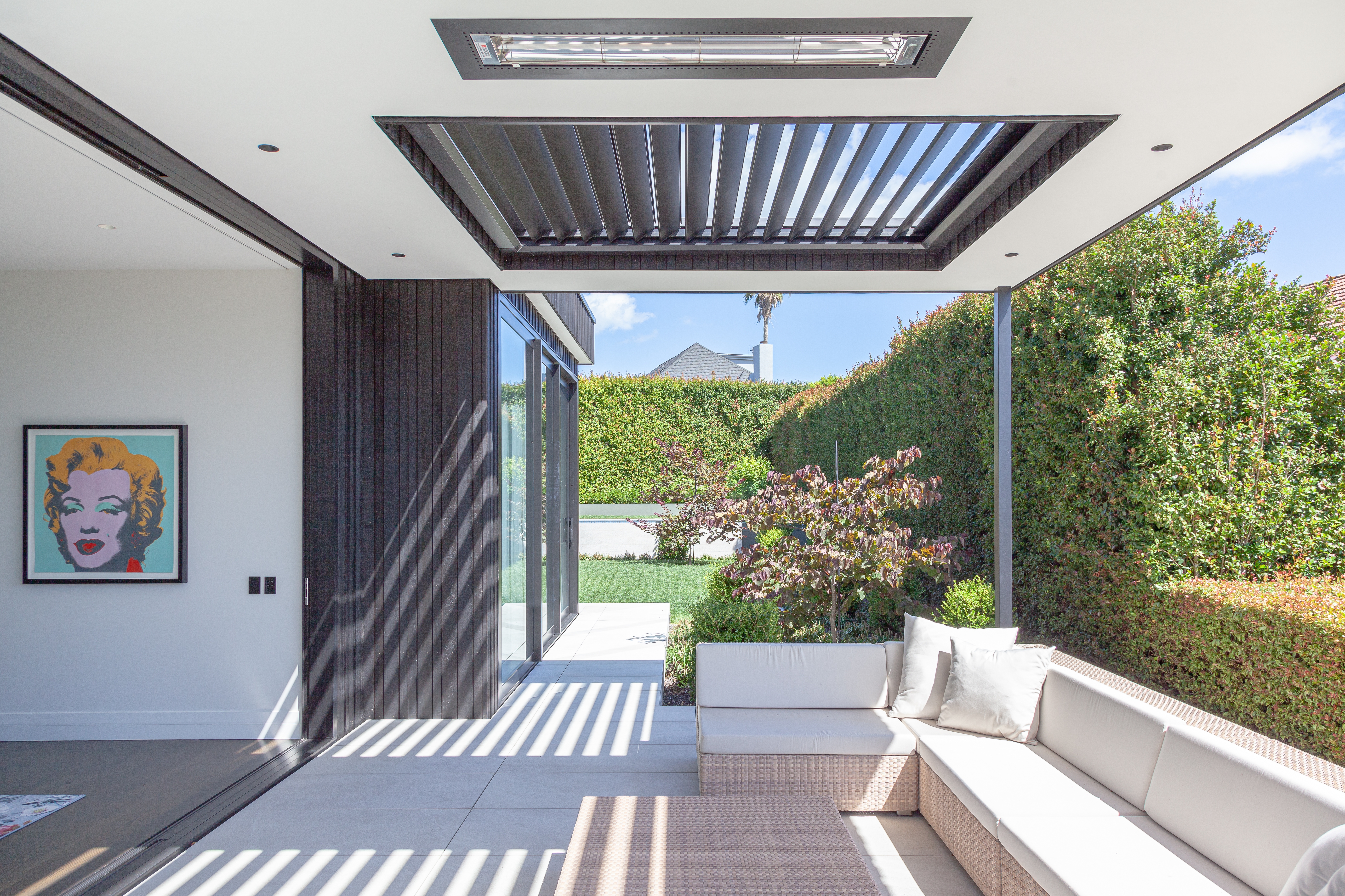 Designed by Jessop Architects, this covered outdoor room extends the living area of a Remuera home. Image: John Williams