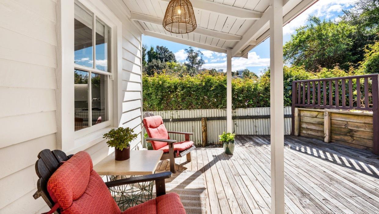 At the rear, the cottage opens out to an expansive deck and patio.