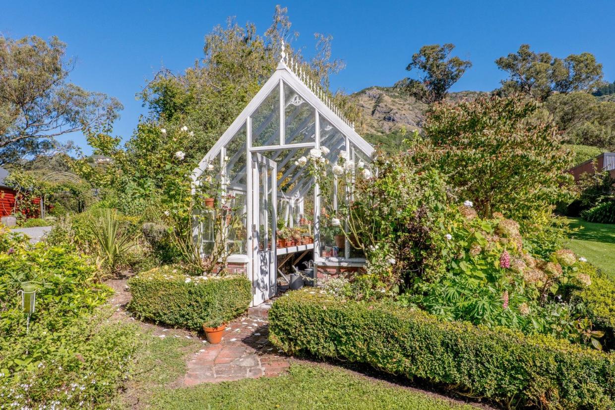 View of the stunning backyard and glasshouse. 
