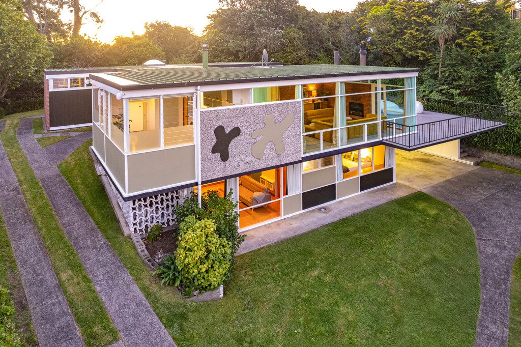 A retro house with large different coloured blobs on the outside.