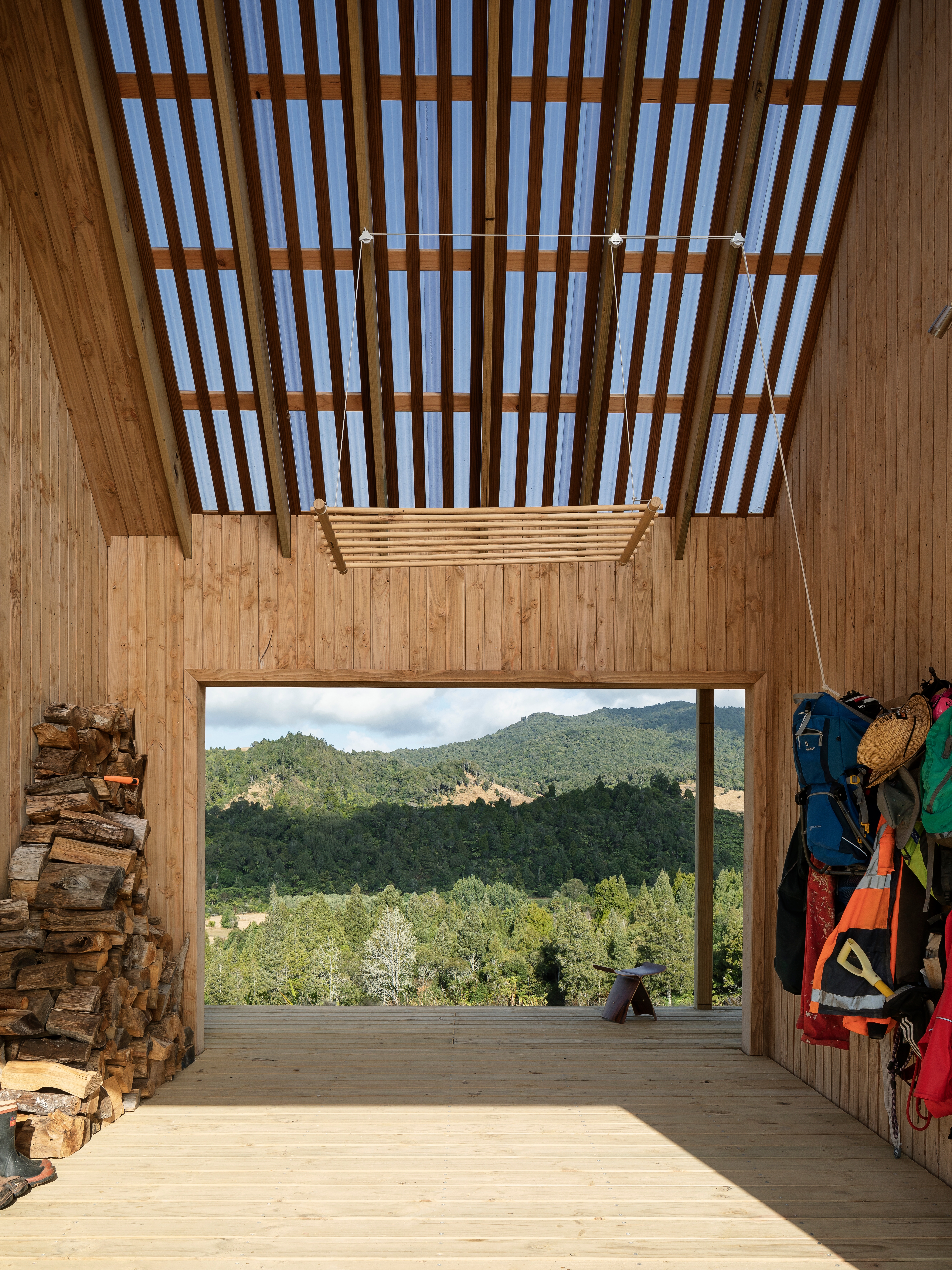 Sarah and James often drag their sofa out onto the breezeway to relax on while taking in the view. This area also provides a spot in which to store firewood, hang all-weather gear and house the clothing rack by Crafty Gatherer hoisted up on a pulley system. “We can close the barn door to block the wind, so it’s great in all seasons,” says Sarah.