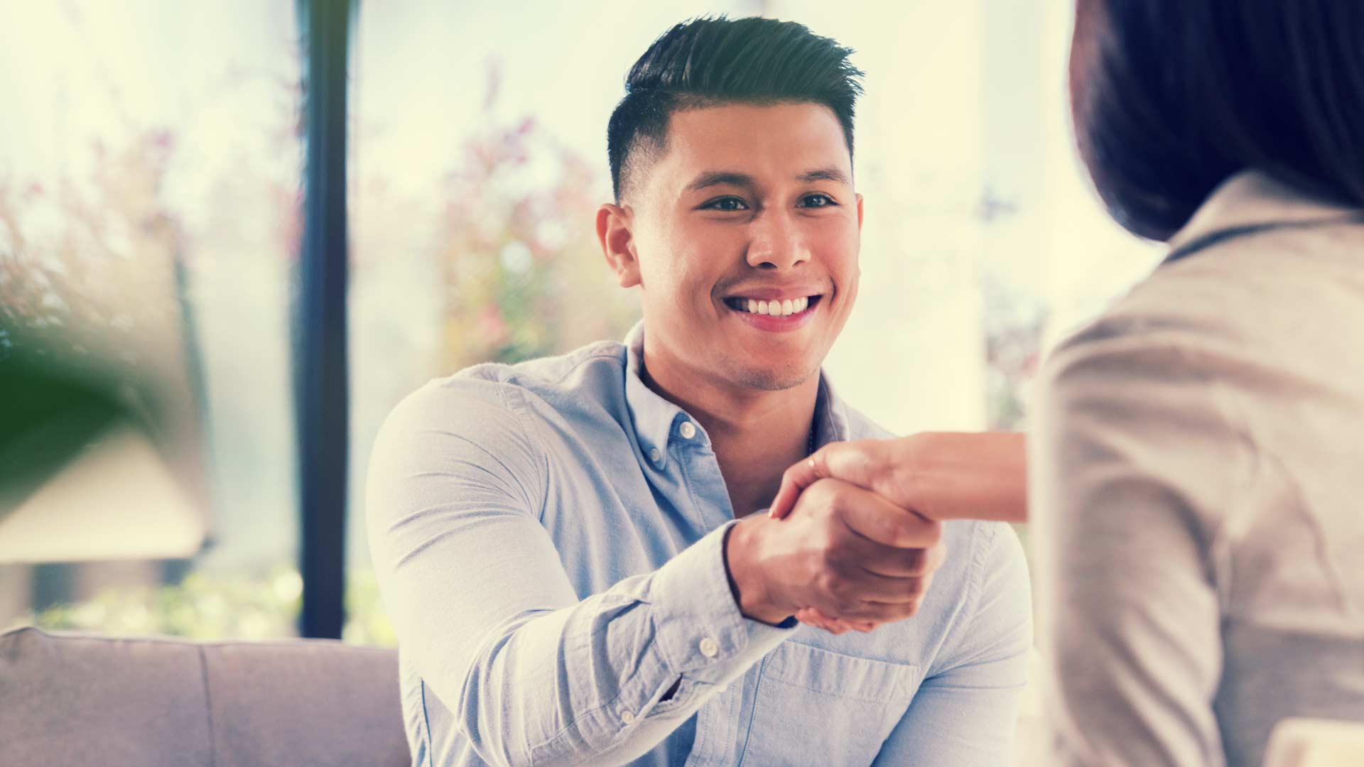 Job interviewer shaking hands with a candidate.