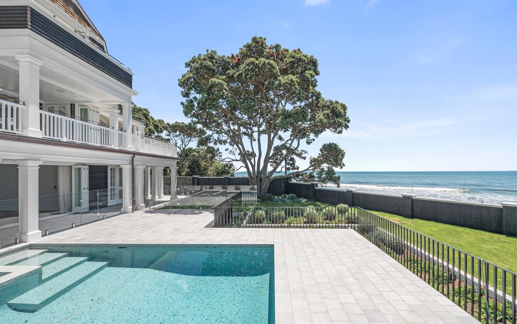 Luxury beachfront home with pool, modern architecture, and direct ocean views.