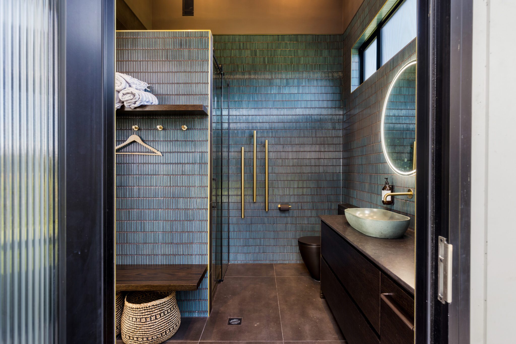 This pool house bathroom by PTG Architects takes the split layout even further by incorporating an outdoor shower into the wider design, as well as a traditional indoor option.  Image above: Cody Woodmass