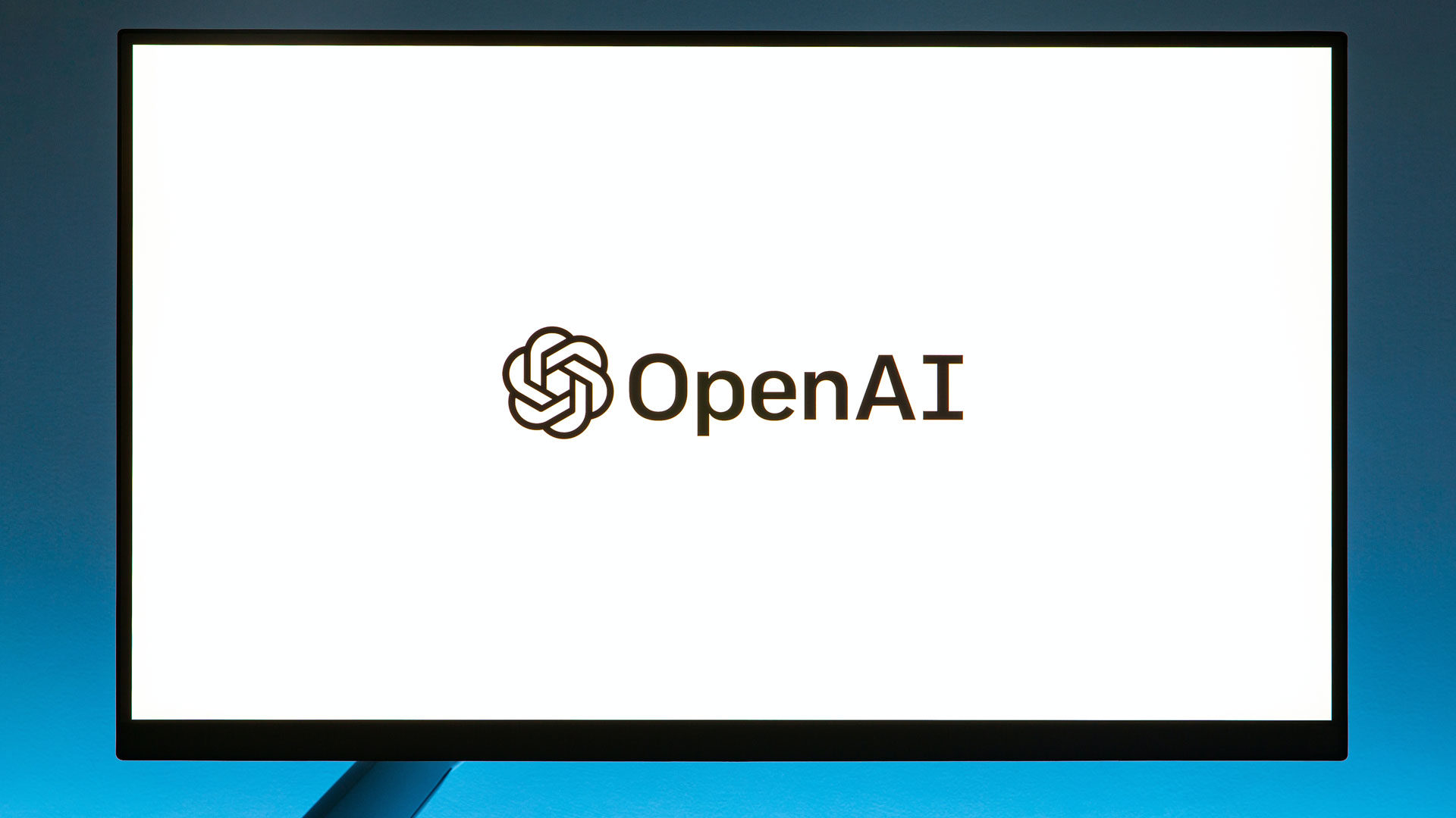 White laptop screen showing the Open AI logo