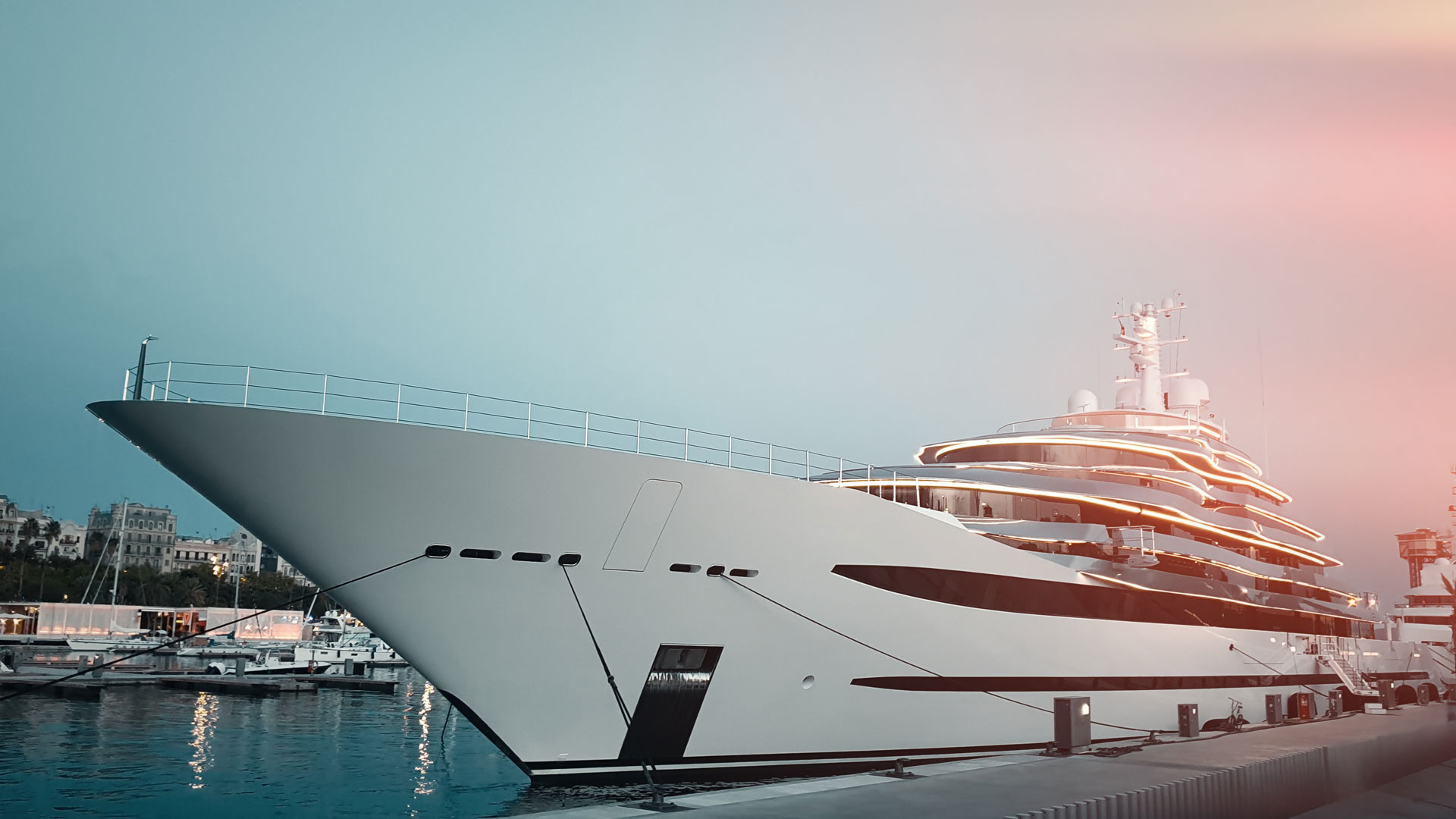 Large, stylish private superyacht moored in a European port.