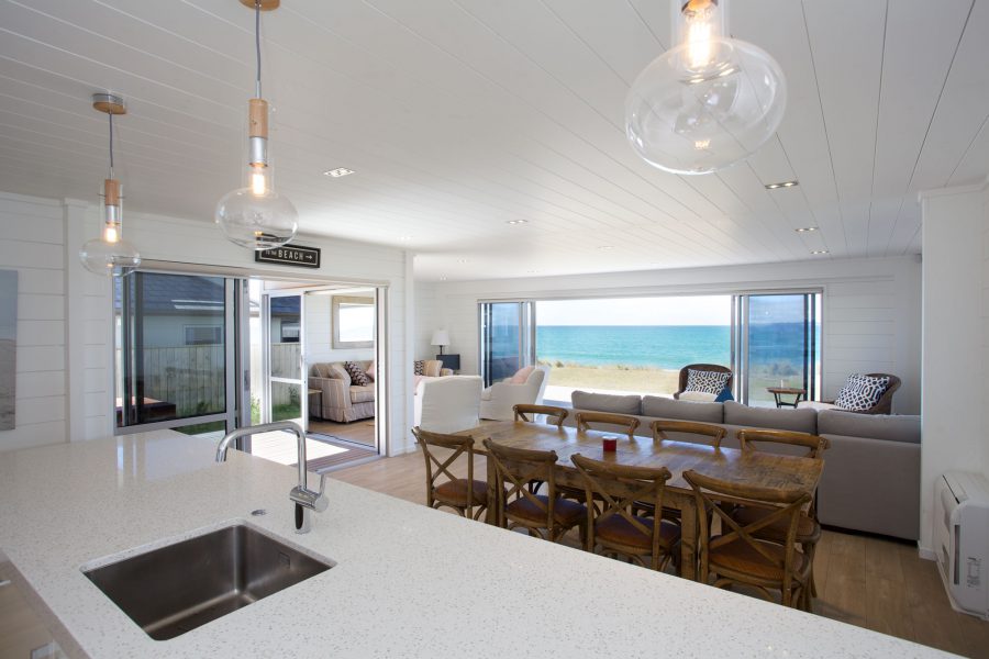 This Lockwood holiday home in Mount Maunganui is painted with a white finish to capture the essence of the coastal setting and create a Cape Cod aesthetic. 