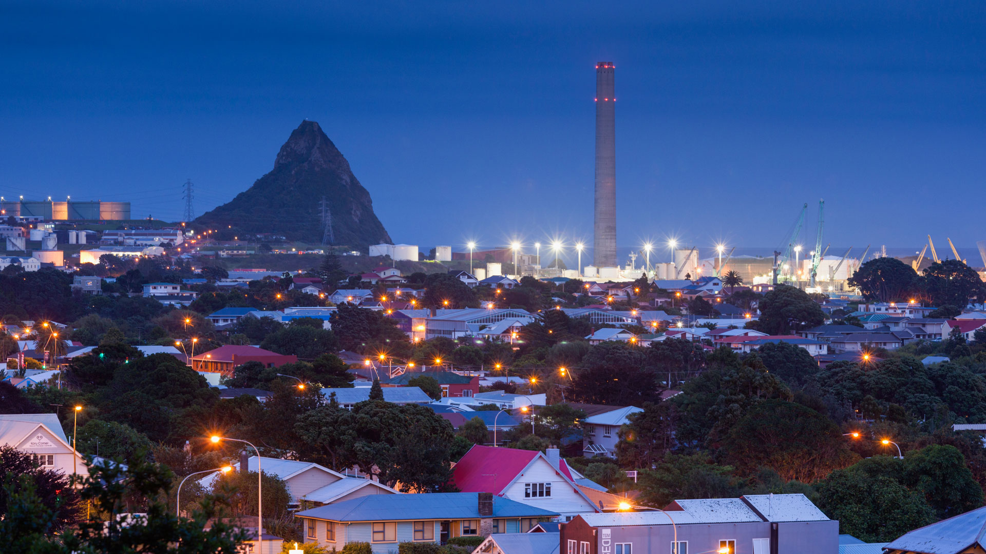 A photo looking across the roofs of homes in New Plymouth at night.