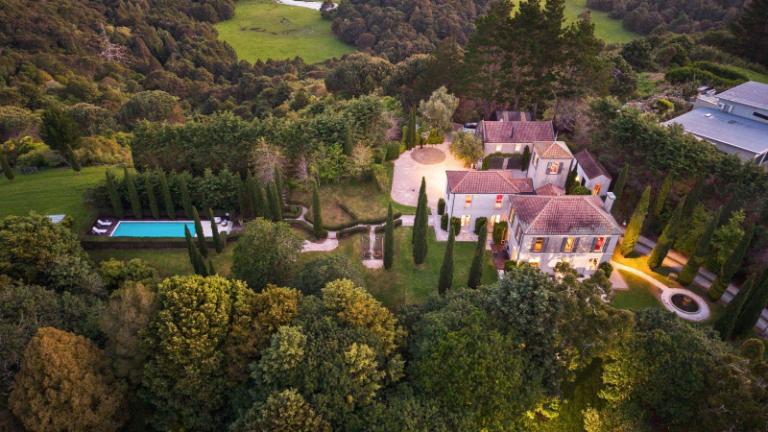 Impressive backyard including a forest and pool.