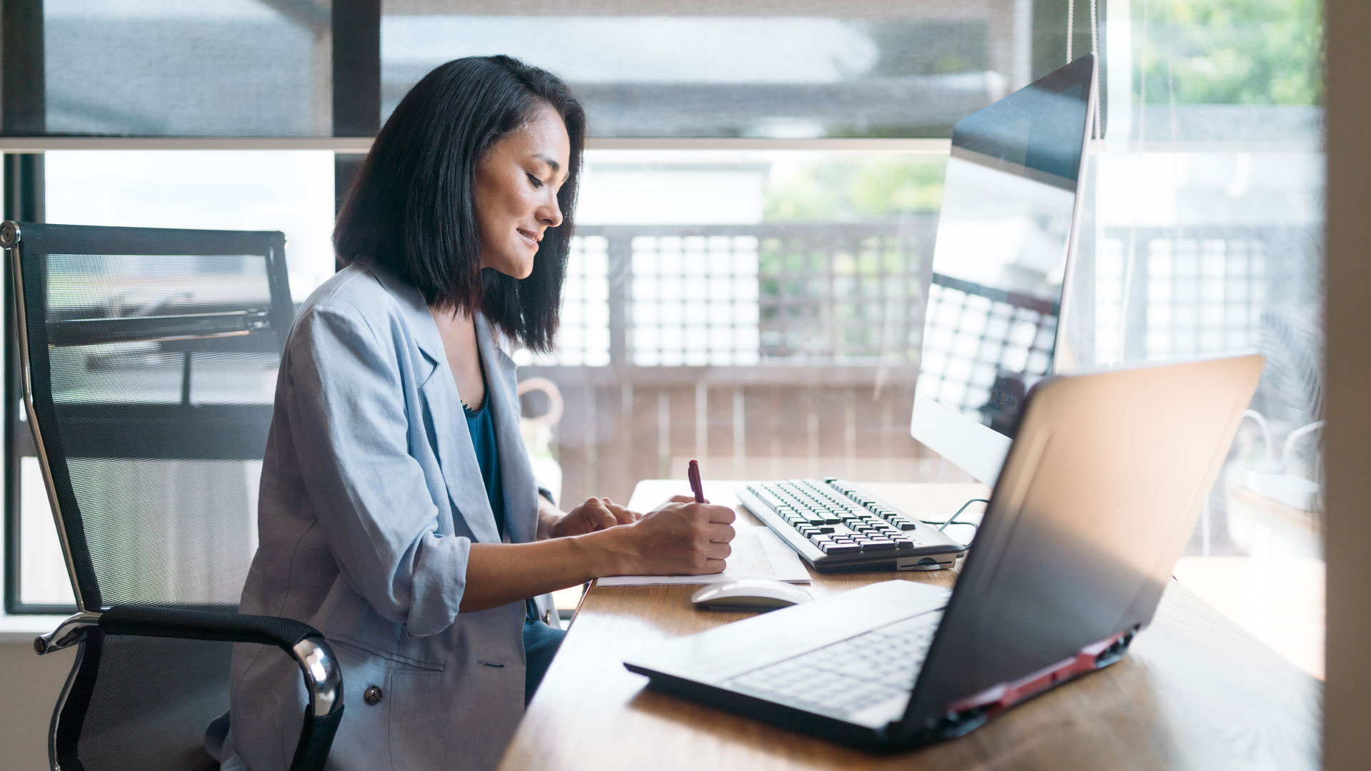 A young professional woman working from her home office.