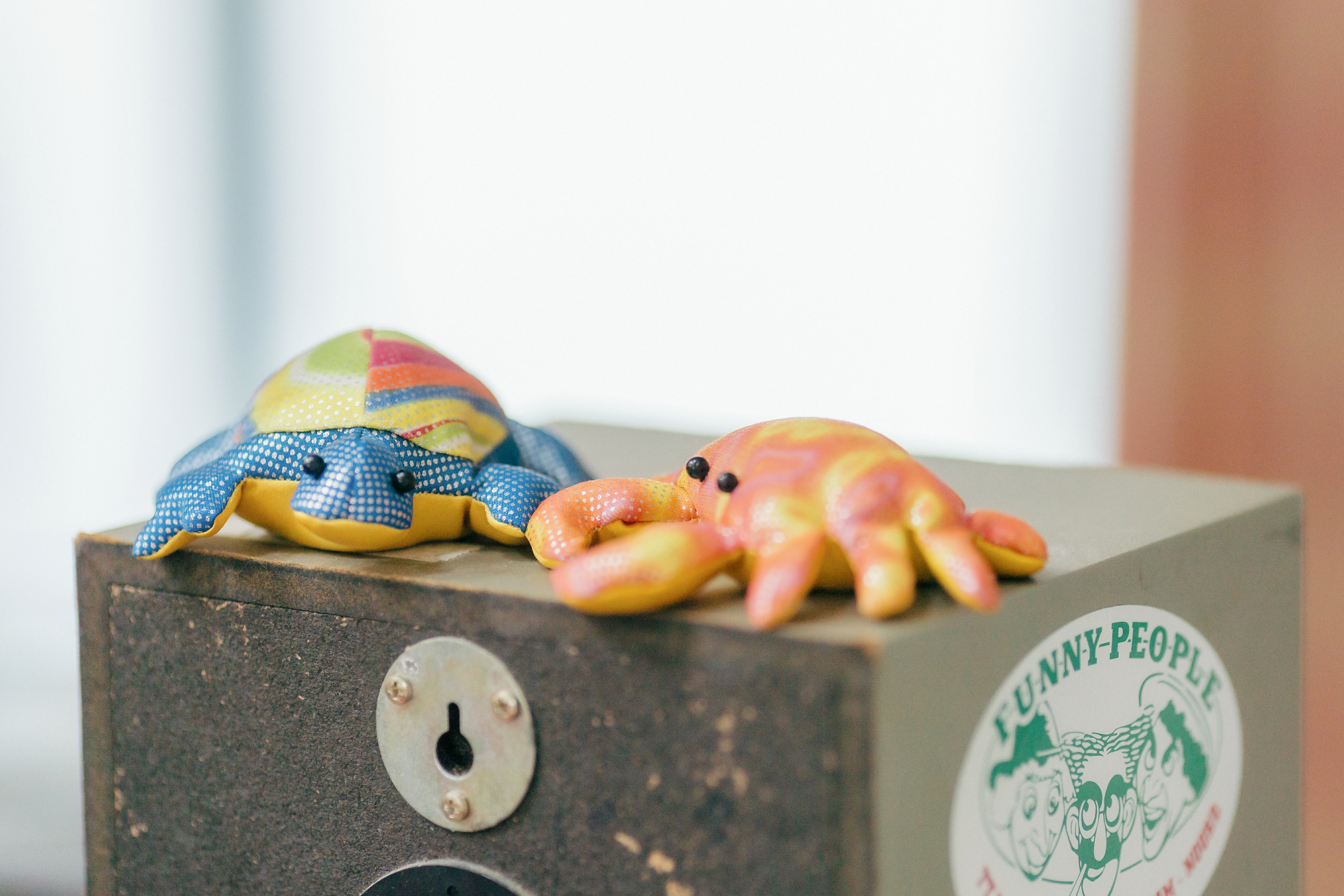 Two bean bag crabs rest on a speaker