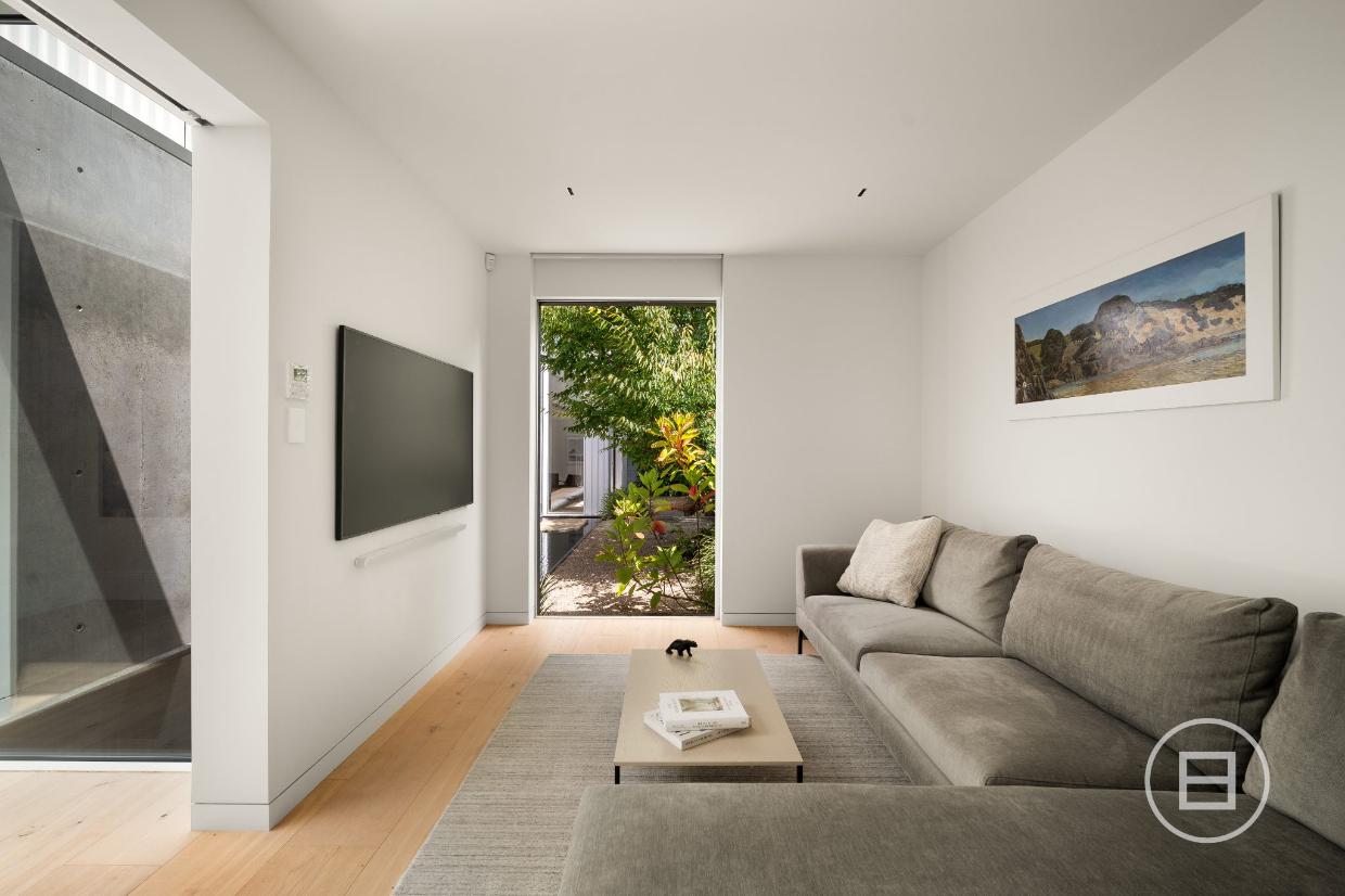 There is good separation between the two living spaces, yet a visual link remains with the window looking out to the courtyard.
