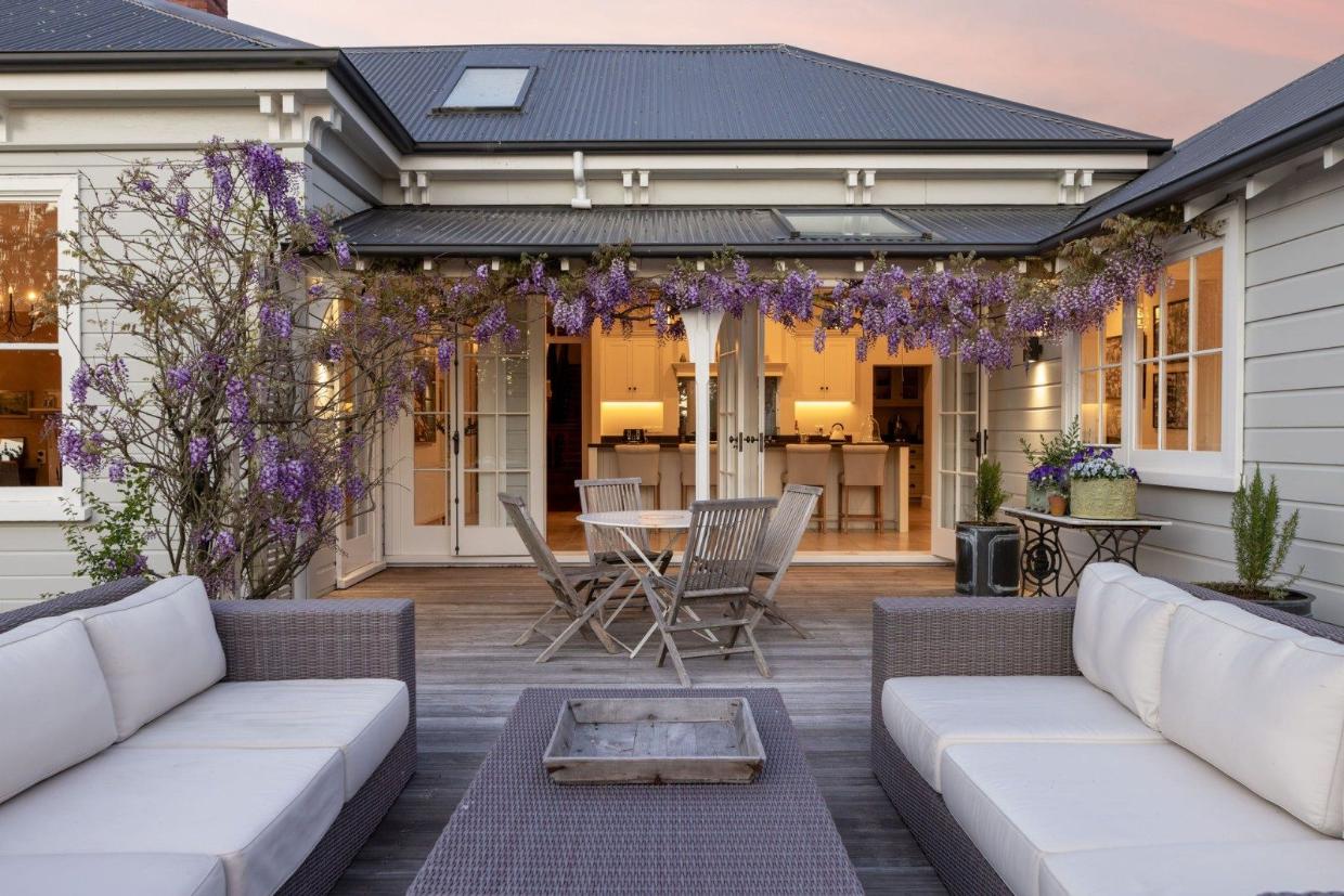 The home features a beautiful garden and a spacious backyard deck, perfect for relaxing or entertaining.