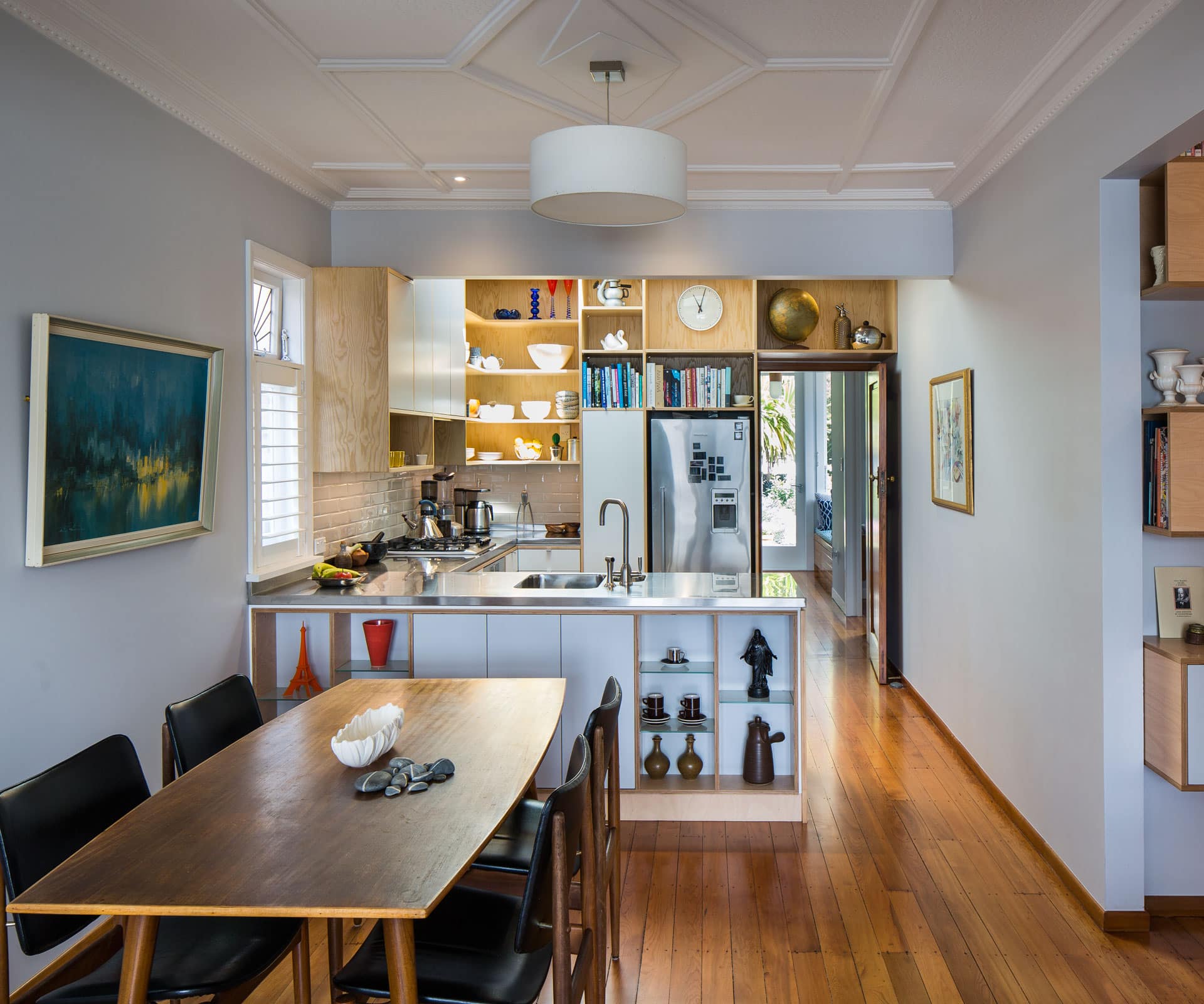 A combination of open and enclosed storage in the kitchen and on the dining facing side of the peninsula creates visual interest and an opportunity to spark conversation. Photograph: Paul McCredie