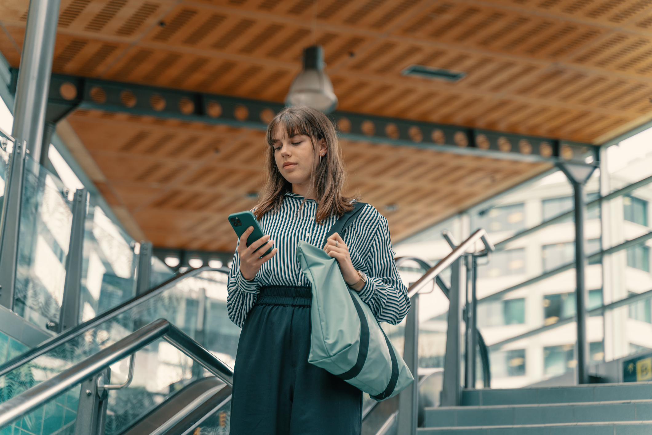 Young businesswoman using phone and Commuting in bus stop