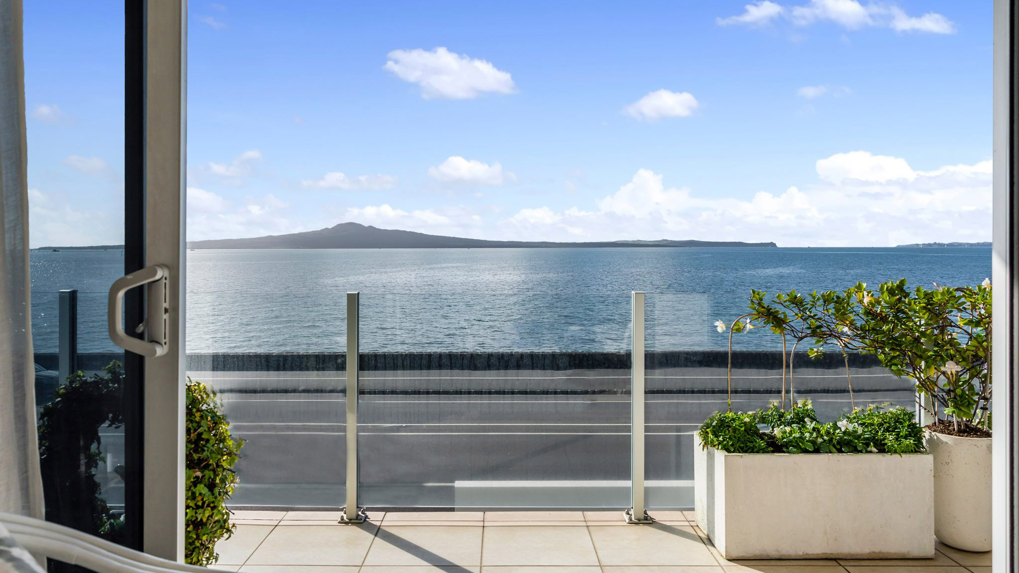 View from living room, across a balcony to Rangitoto Island