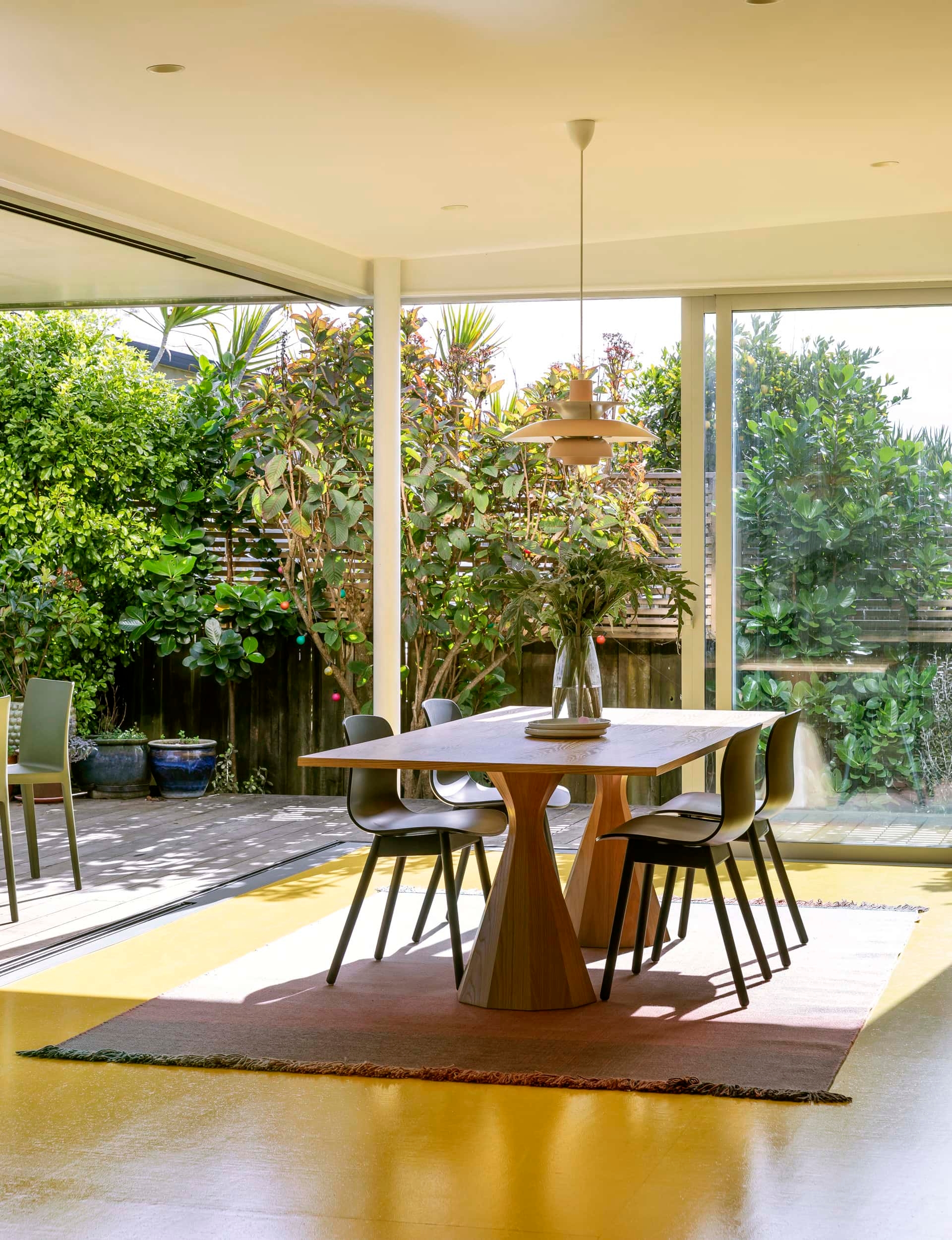 Beautiful dining room with an indoor-outdoor flow to the deck surrounded by native plan