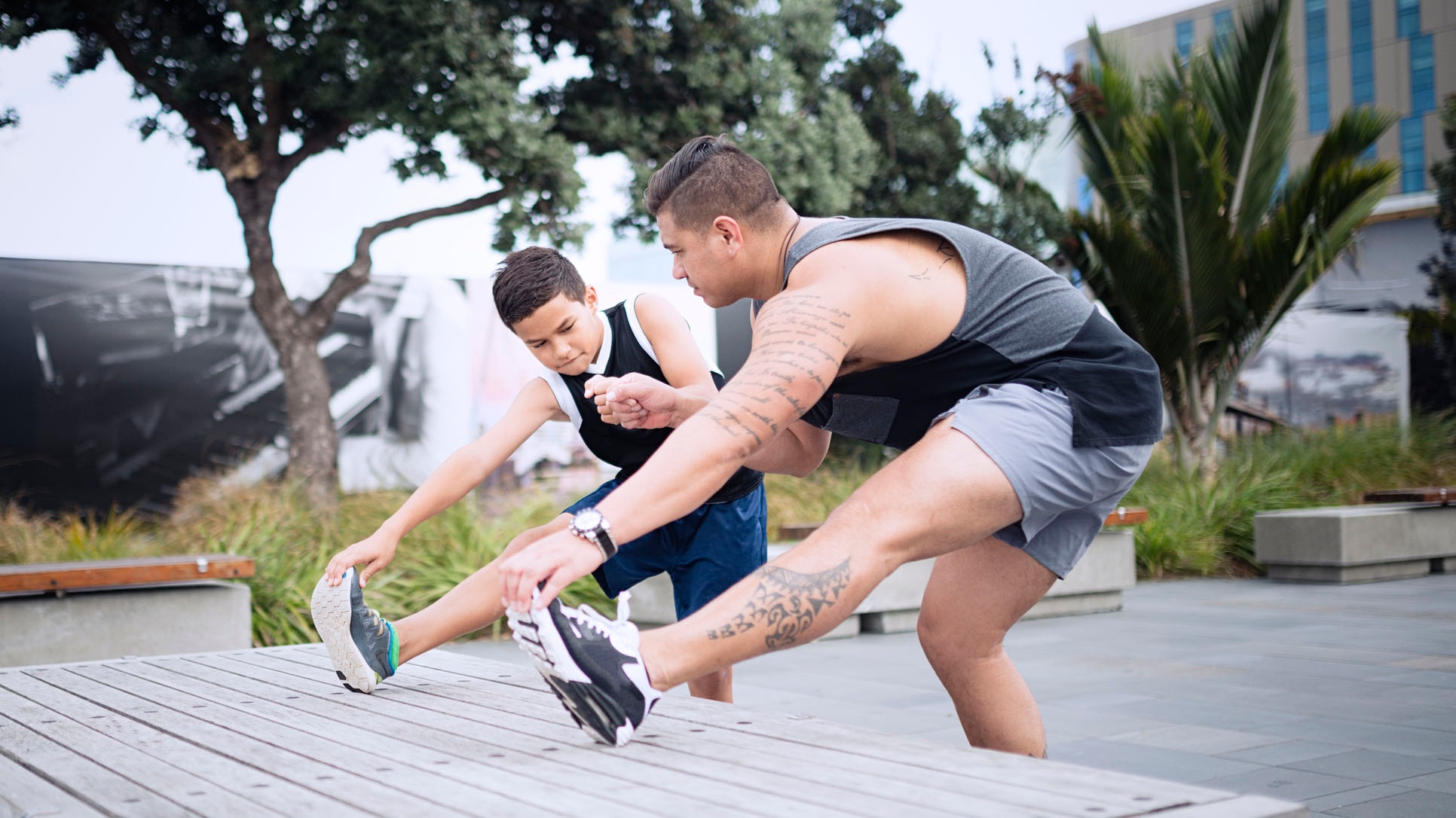 Father and son out exercising in the city.