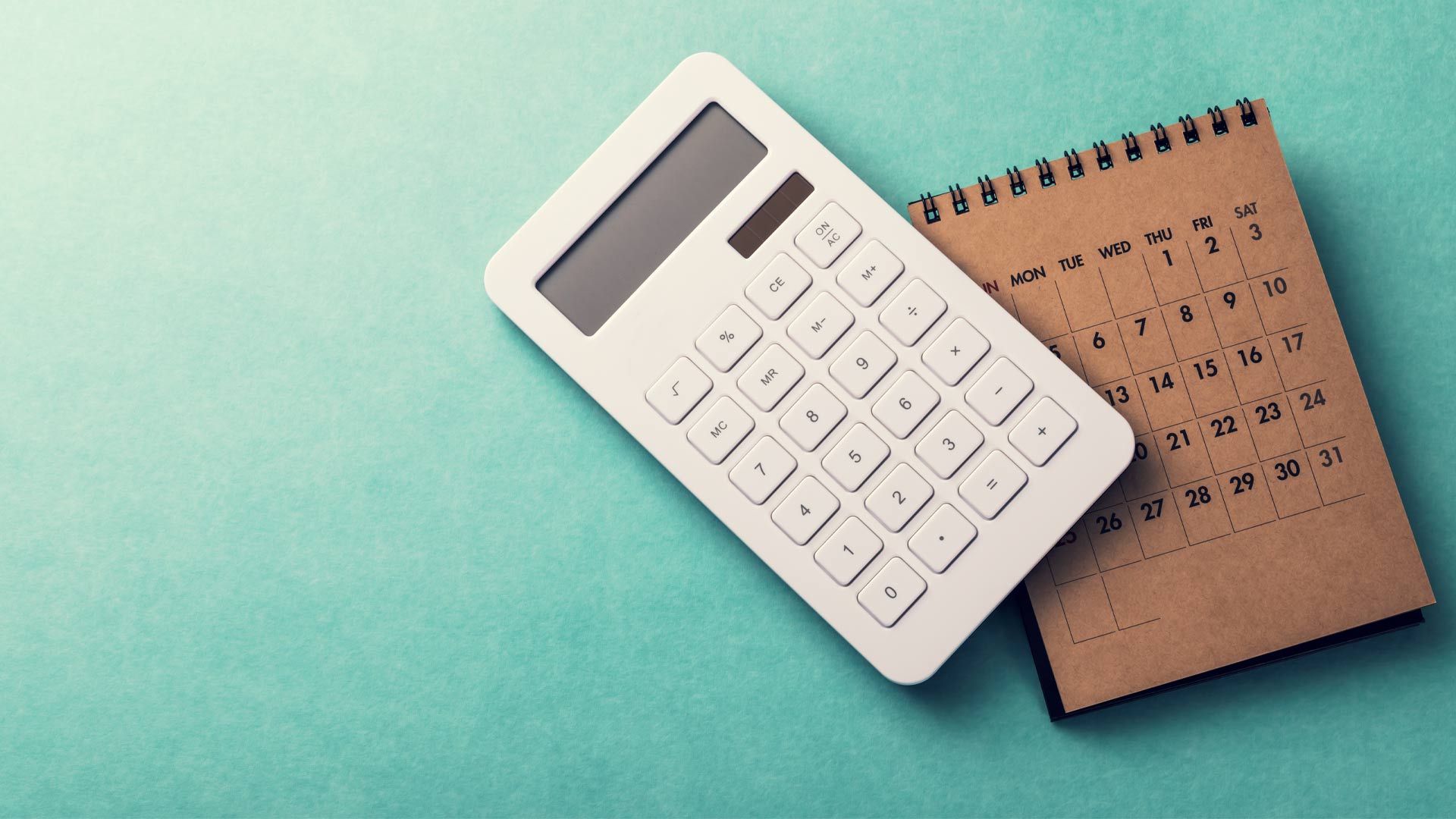 Calculator and calendar used to draw up a budget.