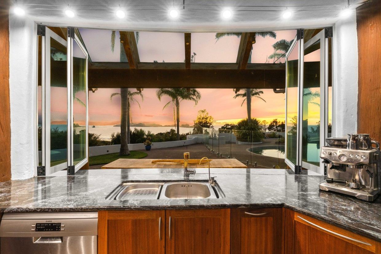 A pass-through window opens out to the pool area. Photo: Bayleys