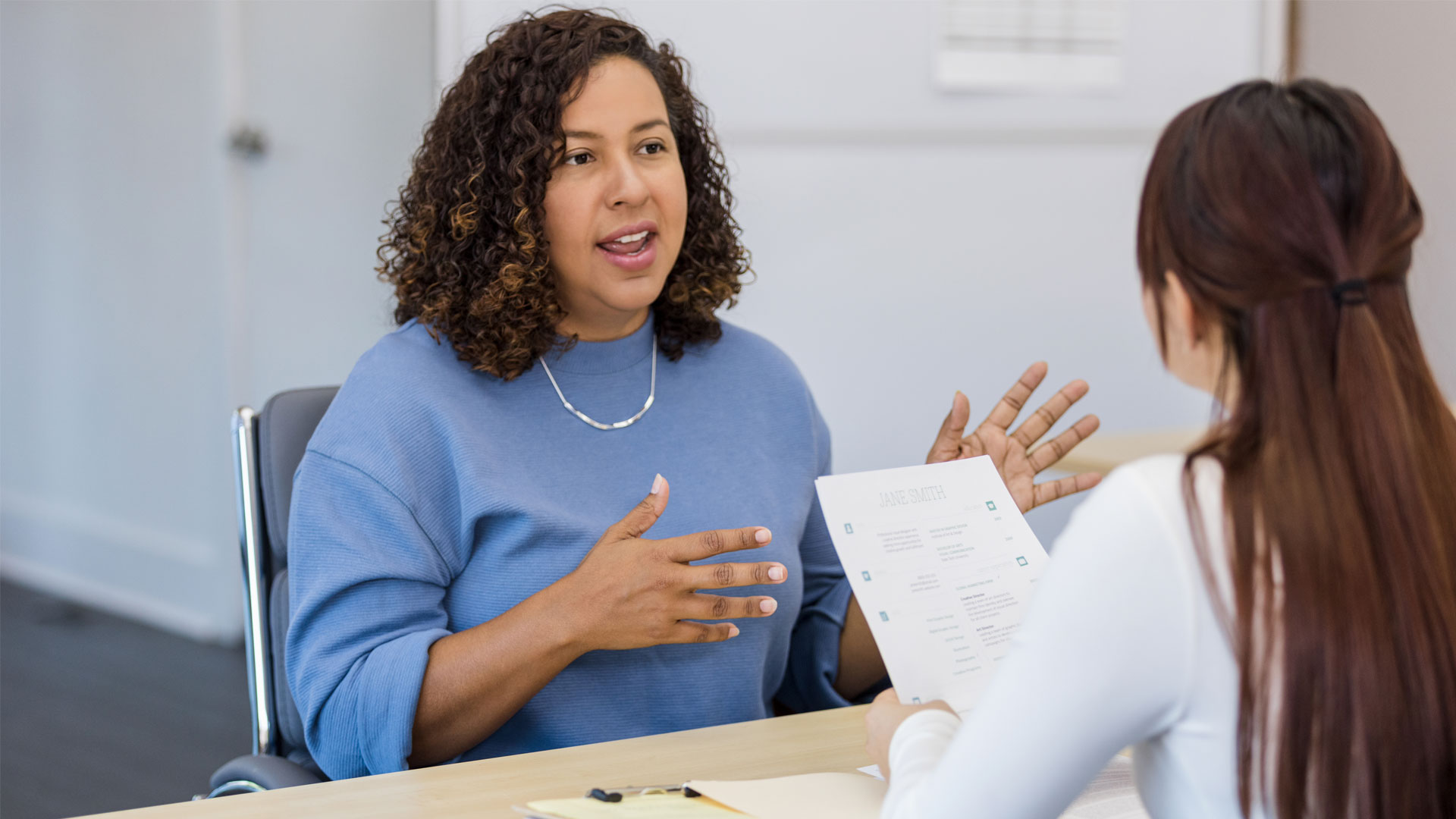 Employee talking to her boss in a performance review.