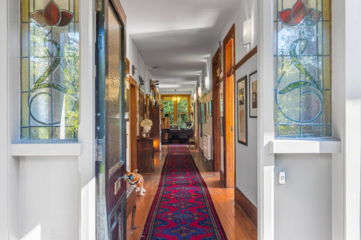 Long hallway with rooms branching off. 