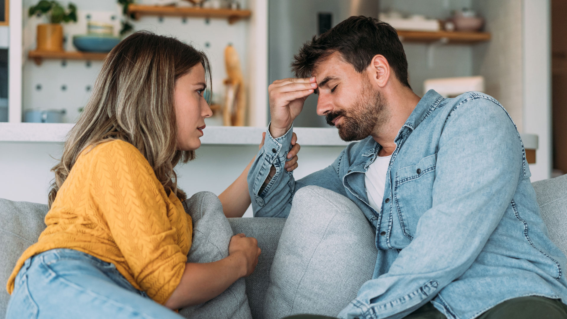 Stressed out couple talking about finances when trying to buy a home in NZ.