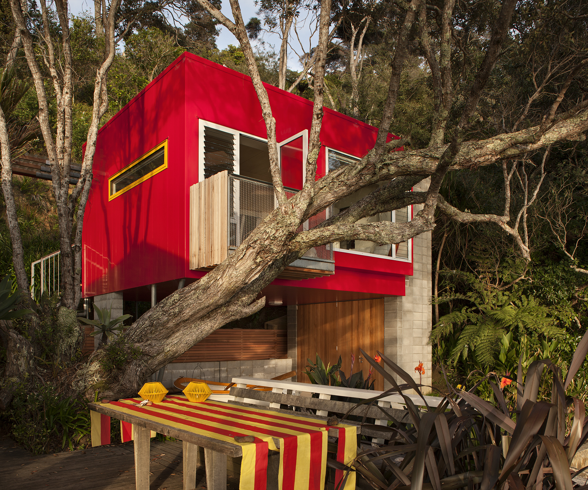 Red house hidden in the trees