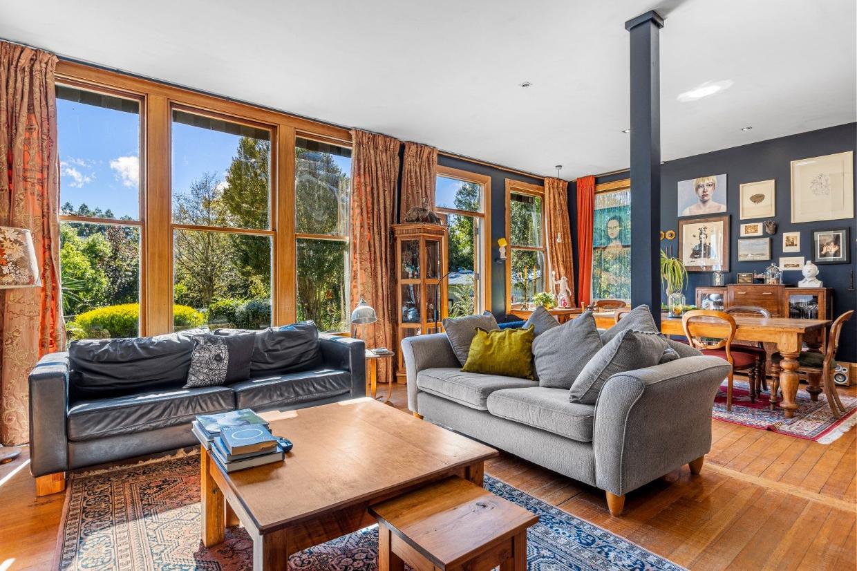 Open living room allowing sun to shine through. 